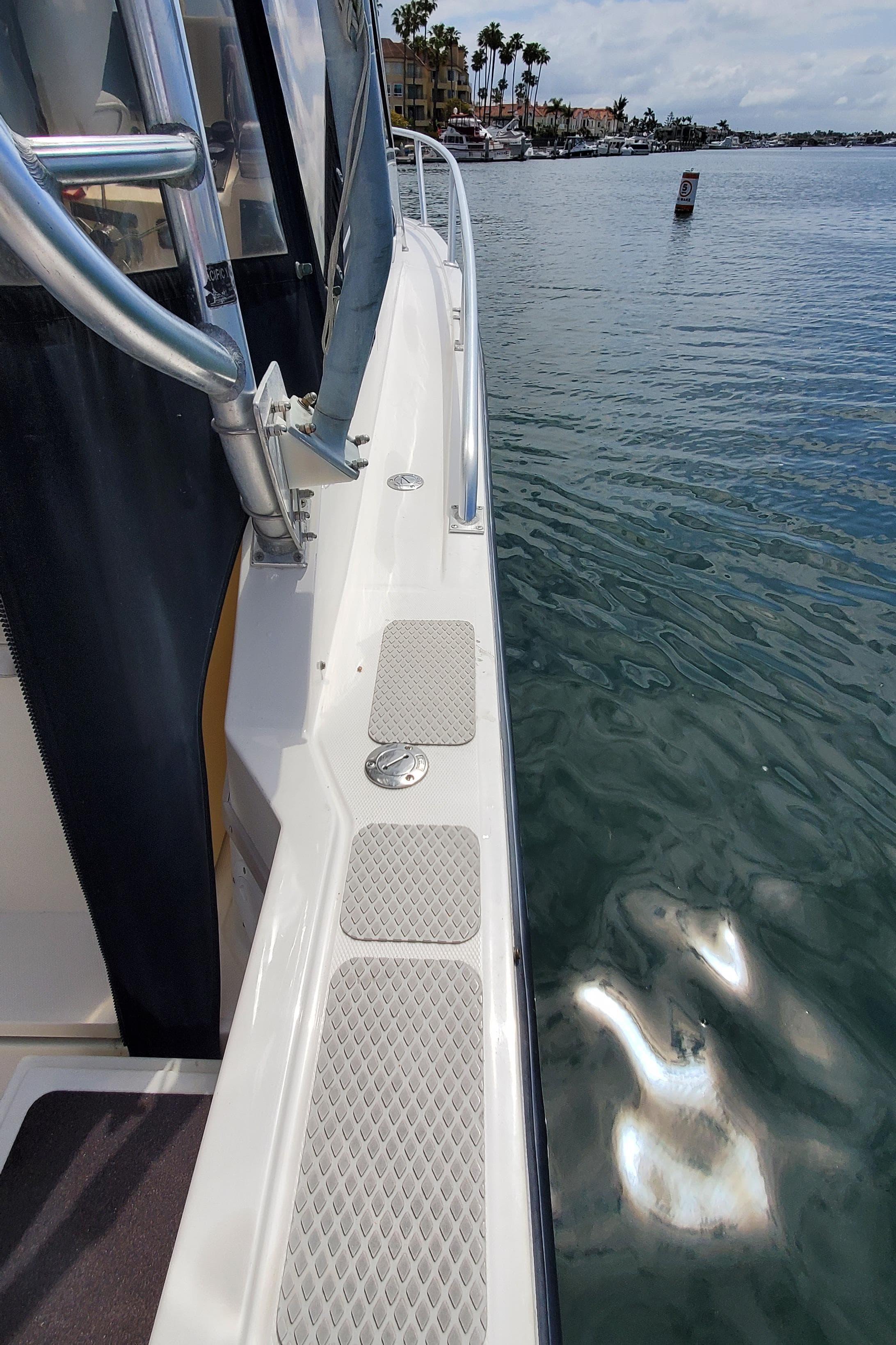 1998 Albemarle 280 Express Fisherman boat docked by calm waters.