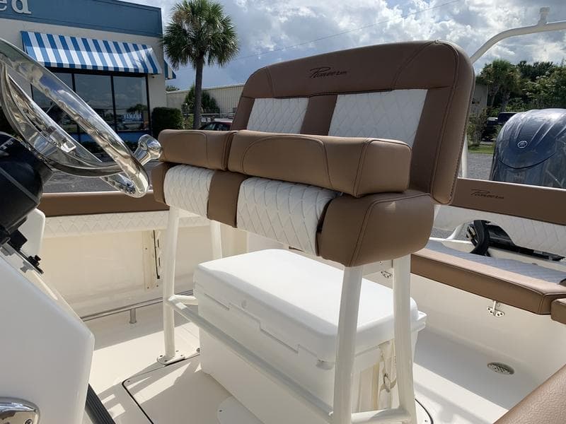 2026 Pioneer ISLANDER 202 boat interior with cushioned seating and steering wheel.