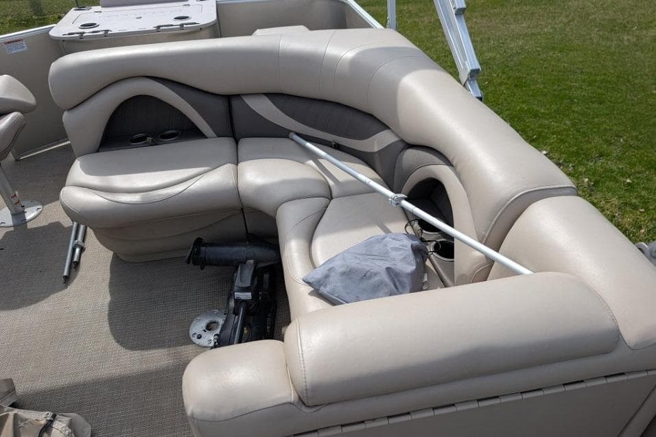 2016 Sylvan Mirage Fish 8520 CNF boat interior with beige seating and fishing equipment.