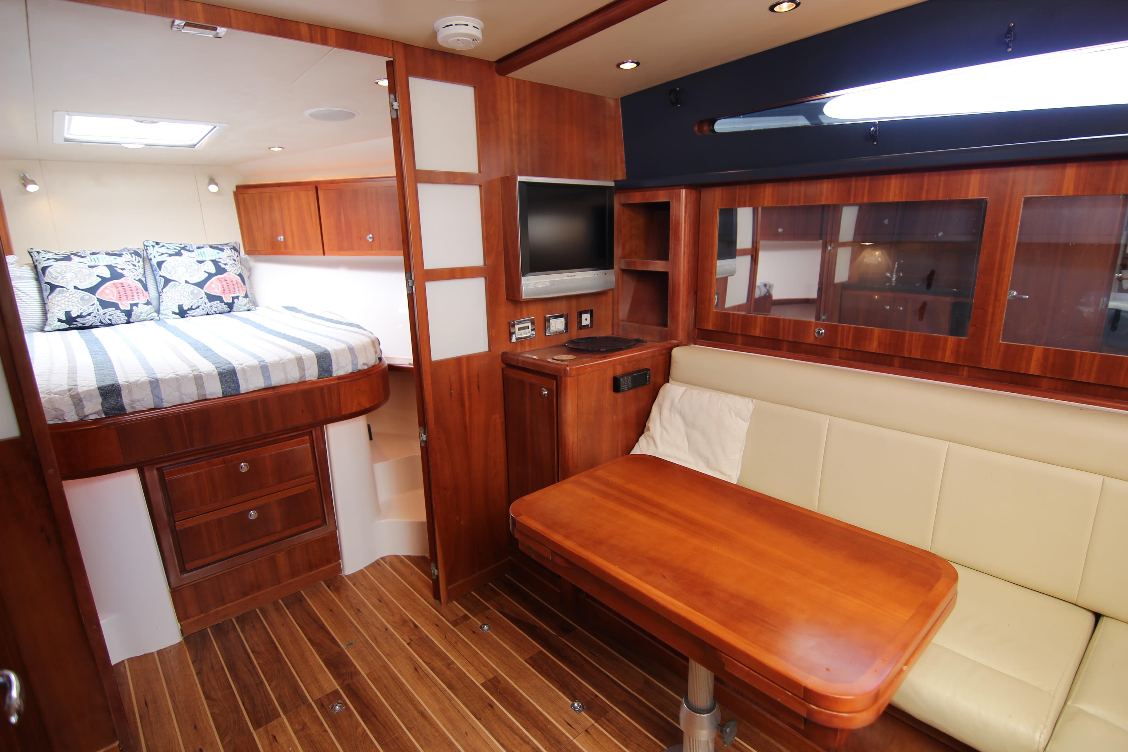 Interior of 2008 Bertram 360 yacht with wood finish, bed, and seating area.