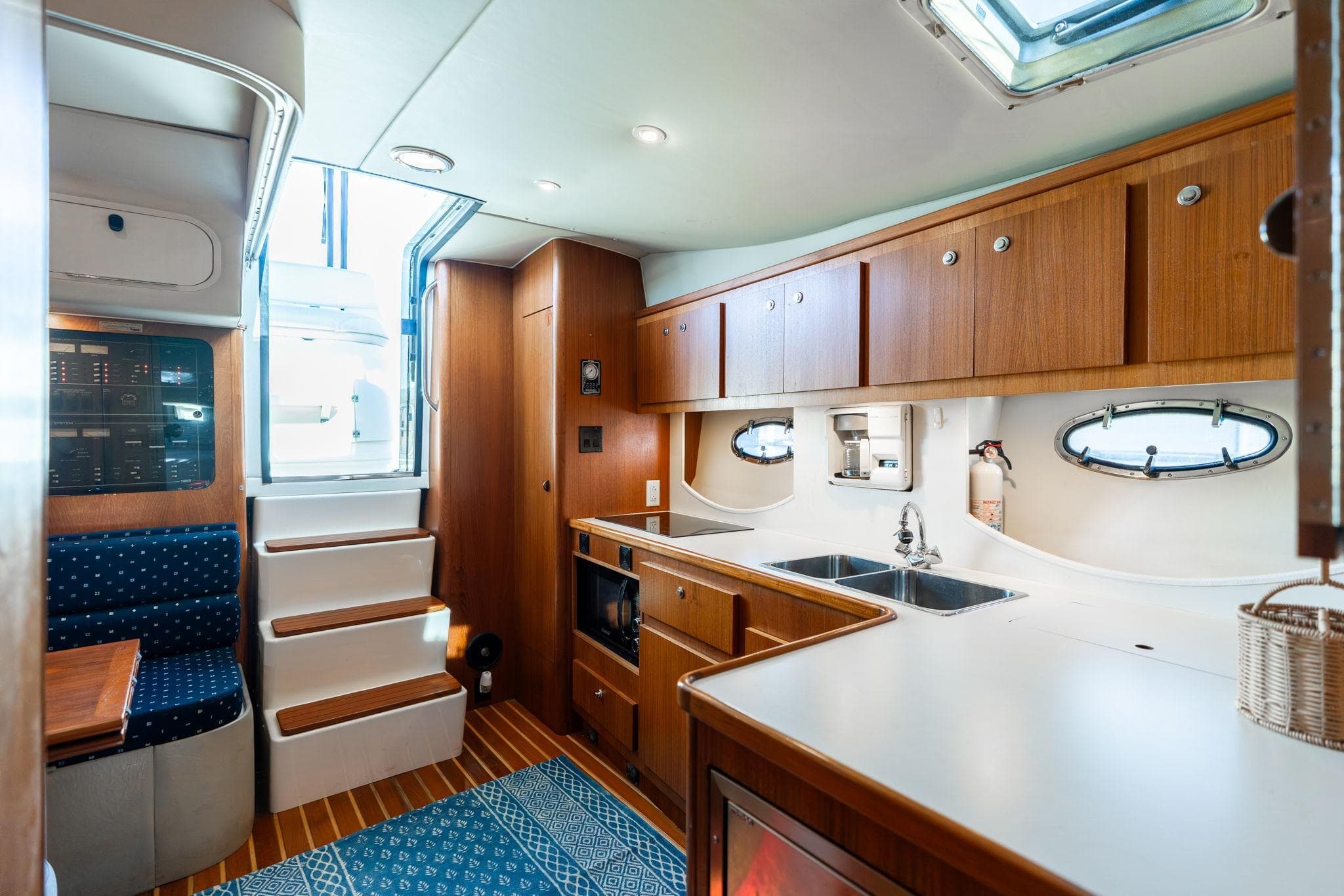 Interior of a 1998 Tiara Yachts 3500 Express, featuring a cozy kitchen and seating area.