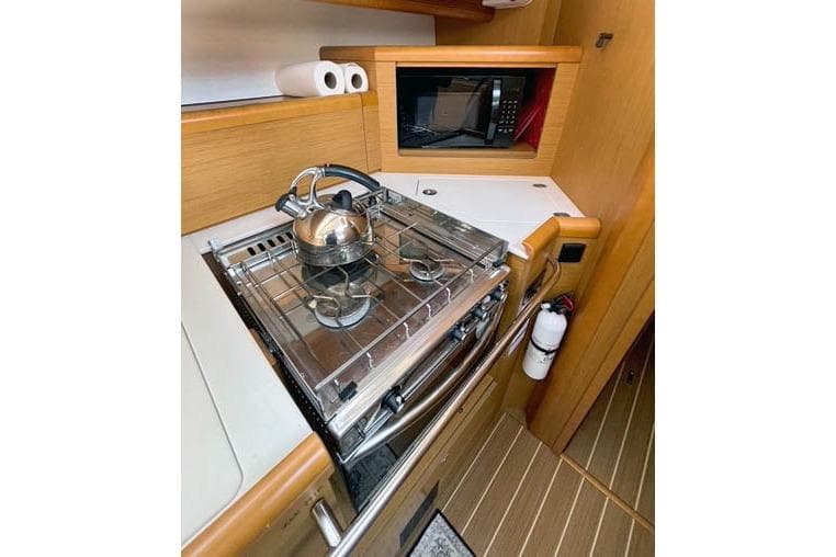 Galley of 2016 Jeanneau Sun Odyssey 50 DS with stove, kettle, and microwave.