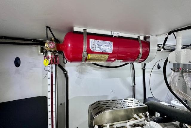 Engine room of 2022 Nordhavn 41 with mounted fire extinguisher system.