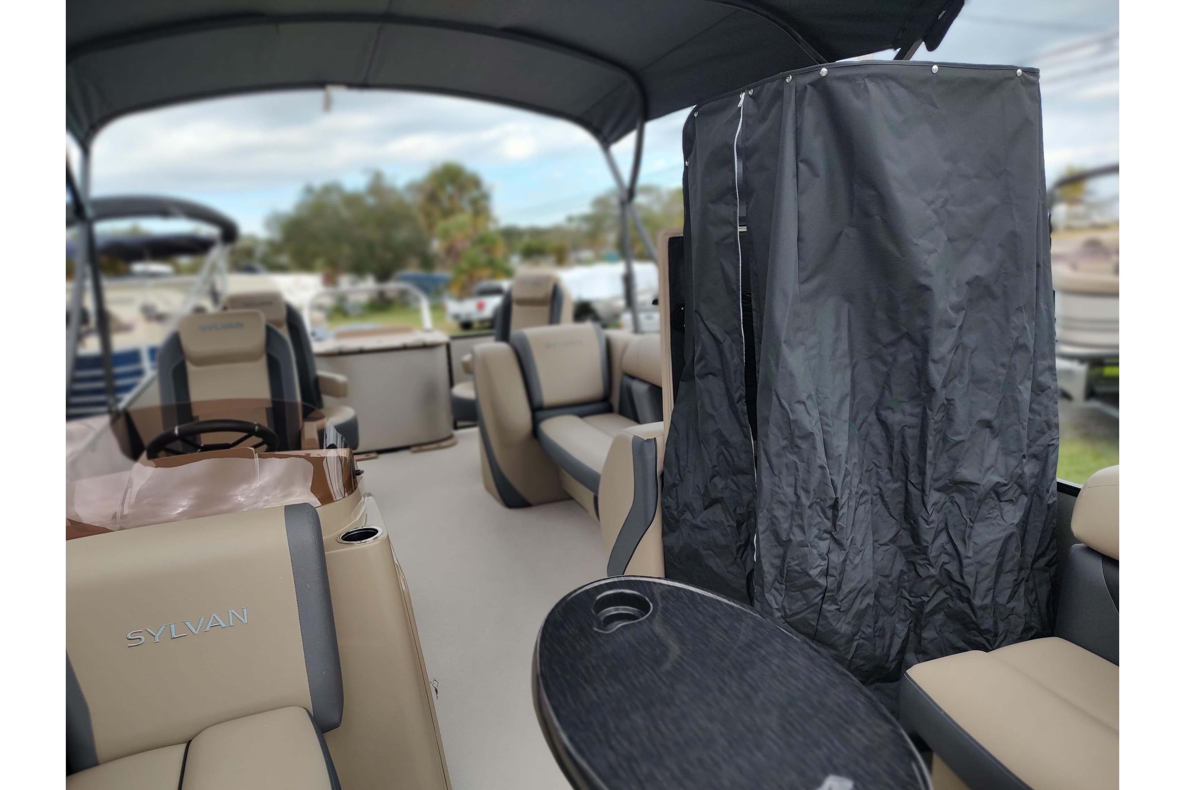 2026 Sylvan Mirage X3 Party Fish boat interior with seating and covered area.