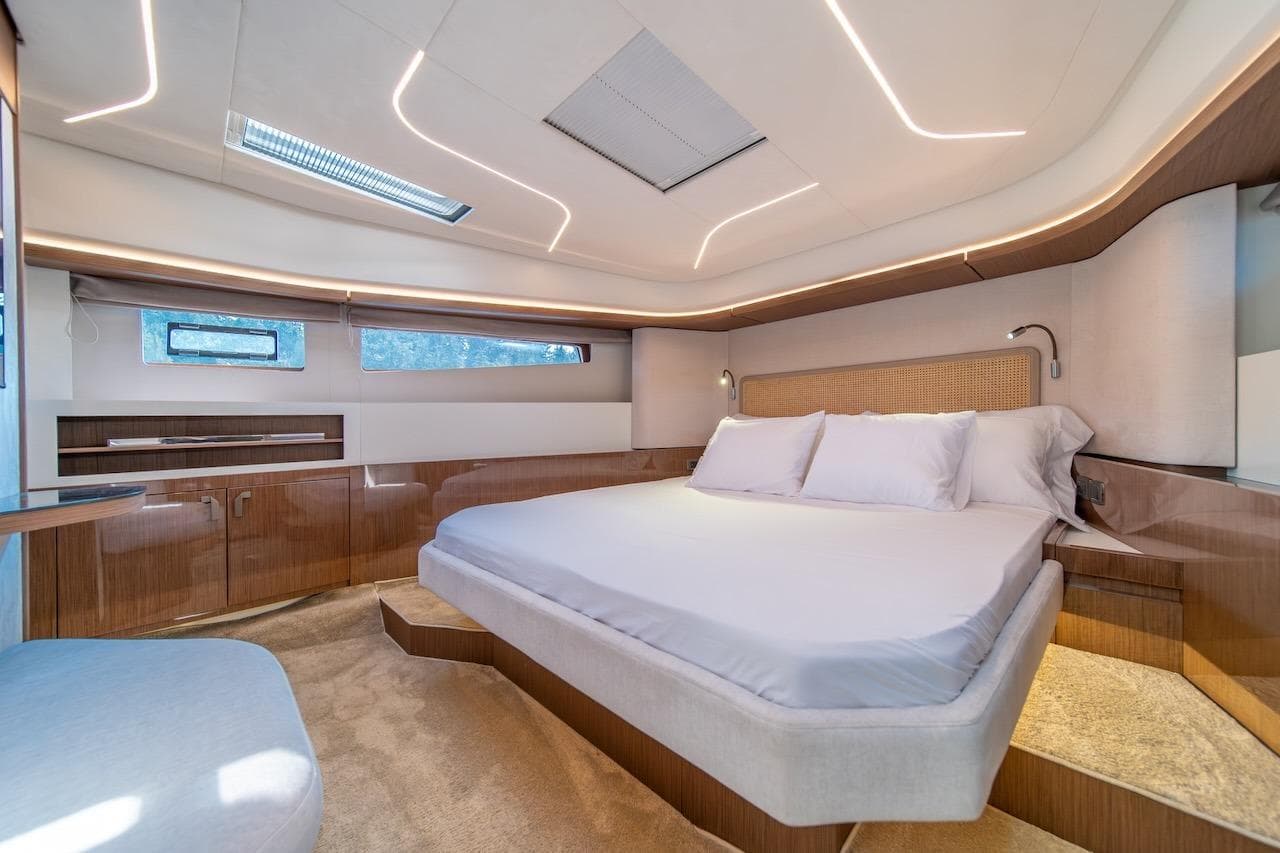 Luxurious 2025 Prestige F4.9 yacht bedroom with modern design and ambient lighting.