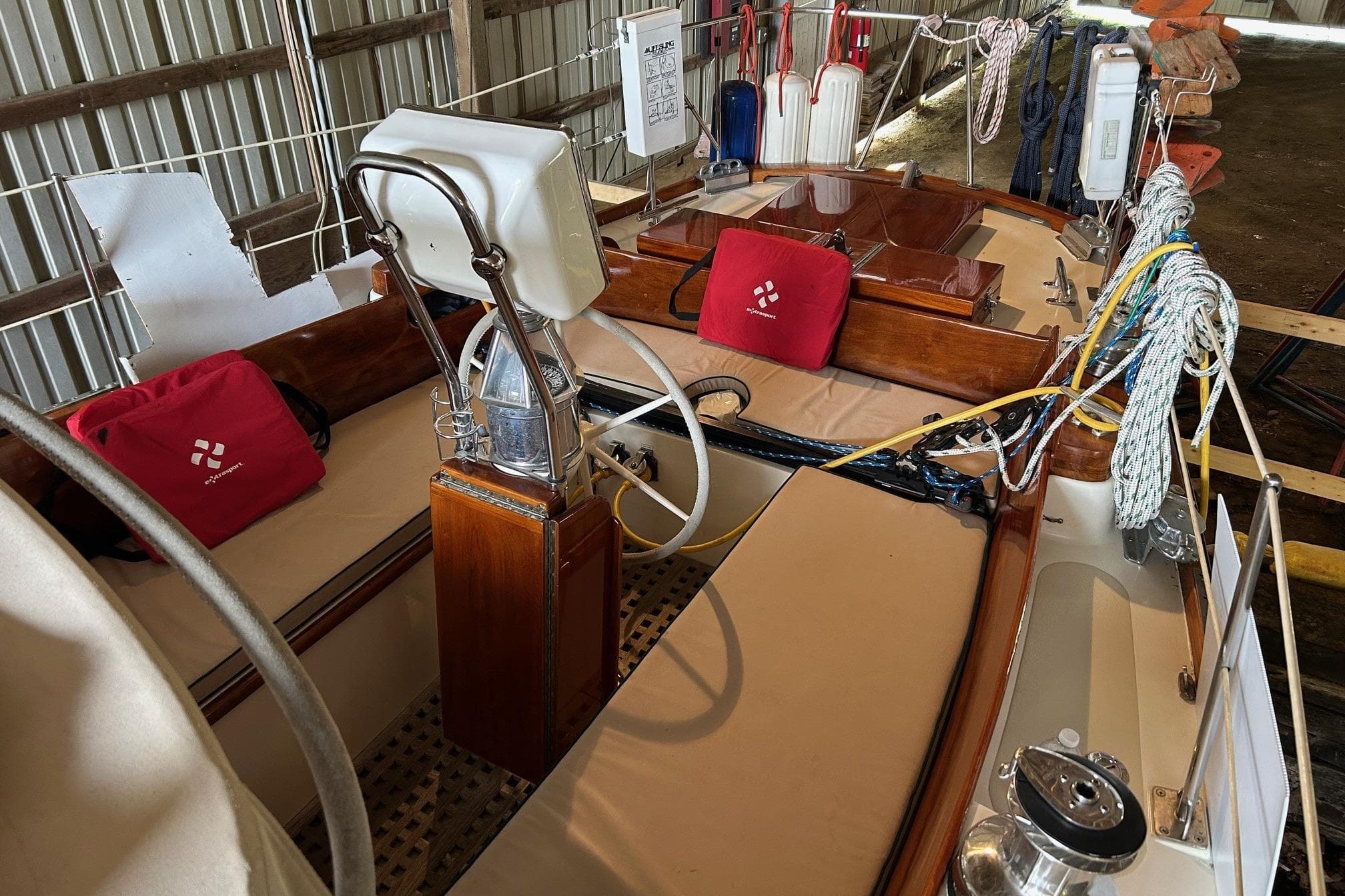 Interior view of a 1970 Hinckley Bermuda 40 sailboat with steering wheel and ropes.