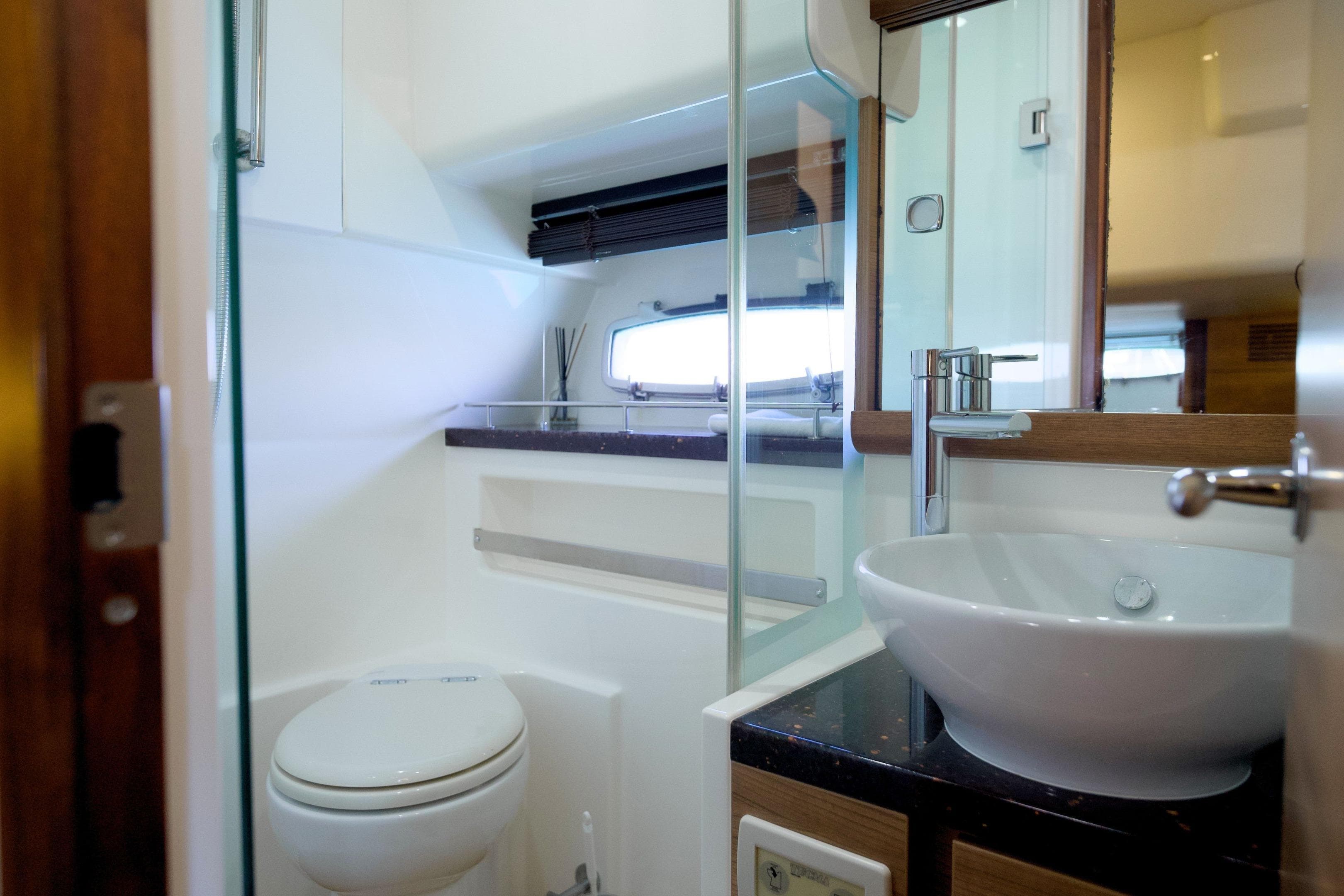 Luxurious bathroom interior of 2012 Sealine SC42 yacht with modern fixtures and elegant design.