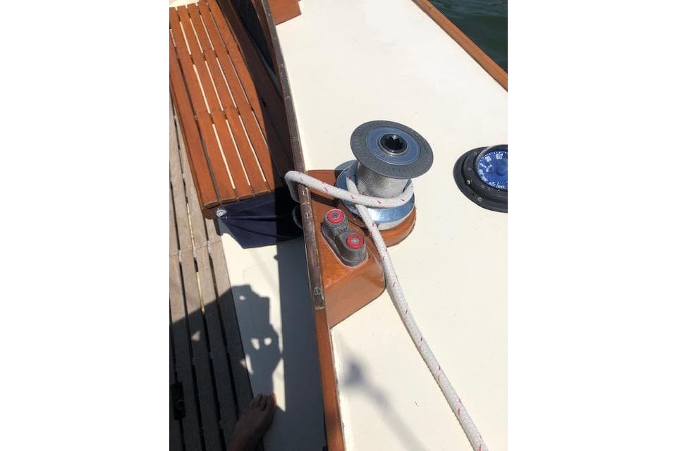 Deck of 1963 Cape Cod Shipbuilding Shields sailboat with winch and rope.