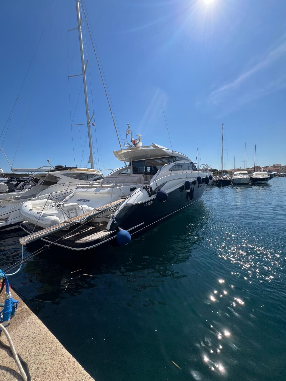 Luxurious 2011 Princess V62 yacht docked in a sunny marina.