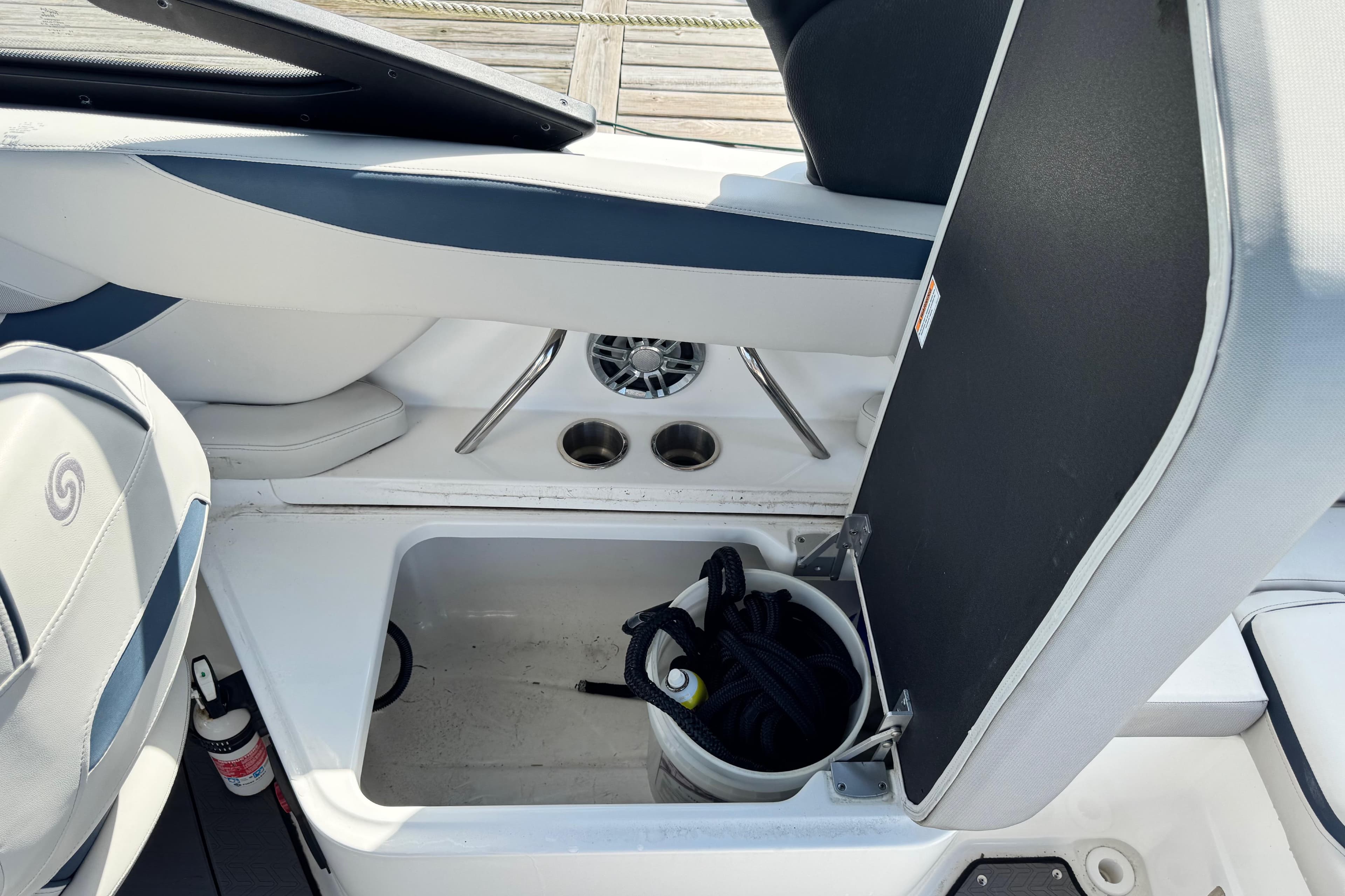 2023 Hurricane SunDeck 2600 OB boat interior storage compartment with bucket and rope.