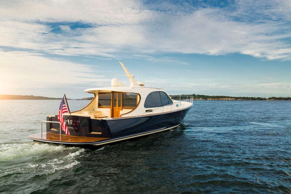 2026 Palm Beach Motor Yachts PB55 cruising on open water under a clear sky.