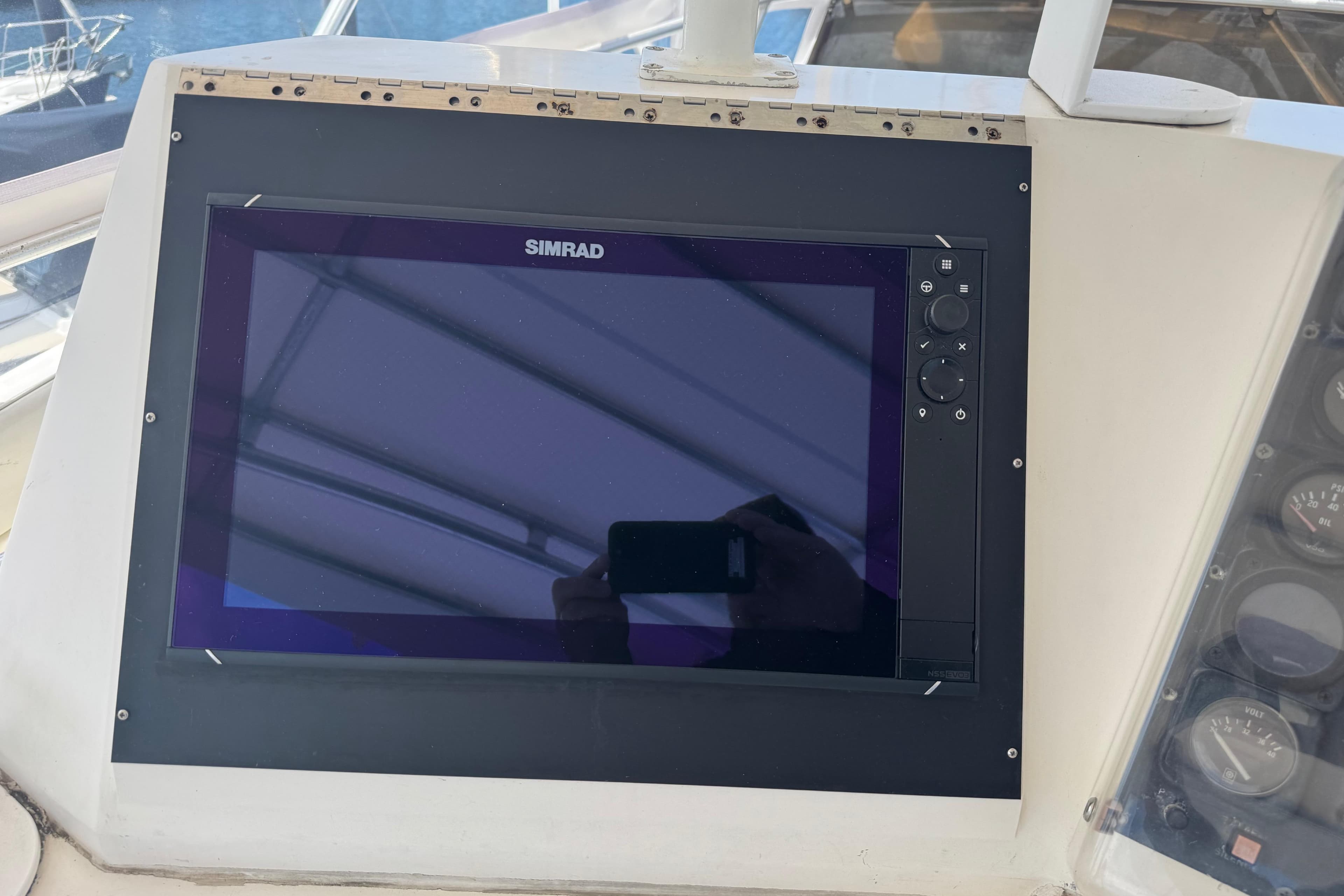 Simrad navigation display on 1988 Bertram 50 Convertible yacht dashboard.