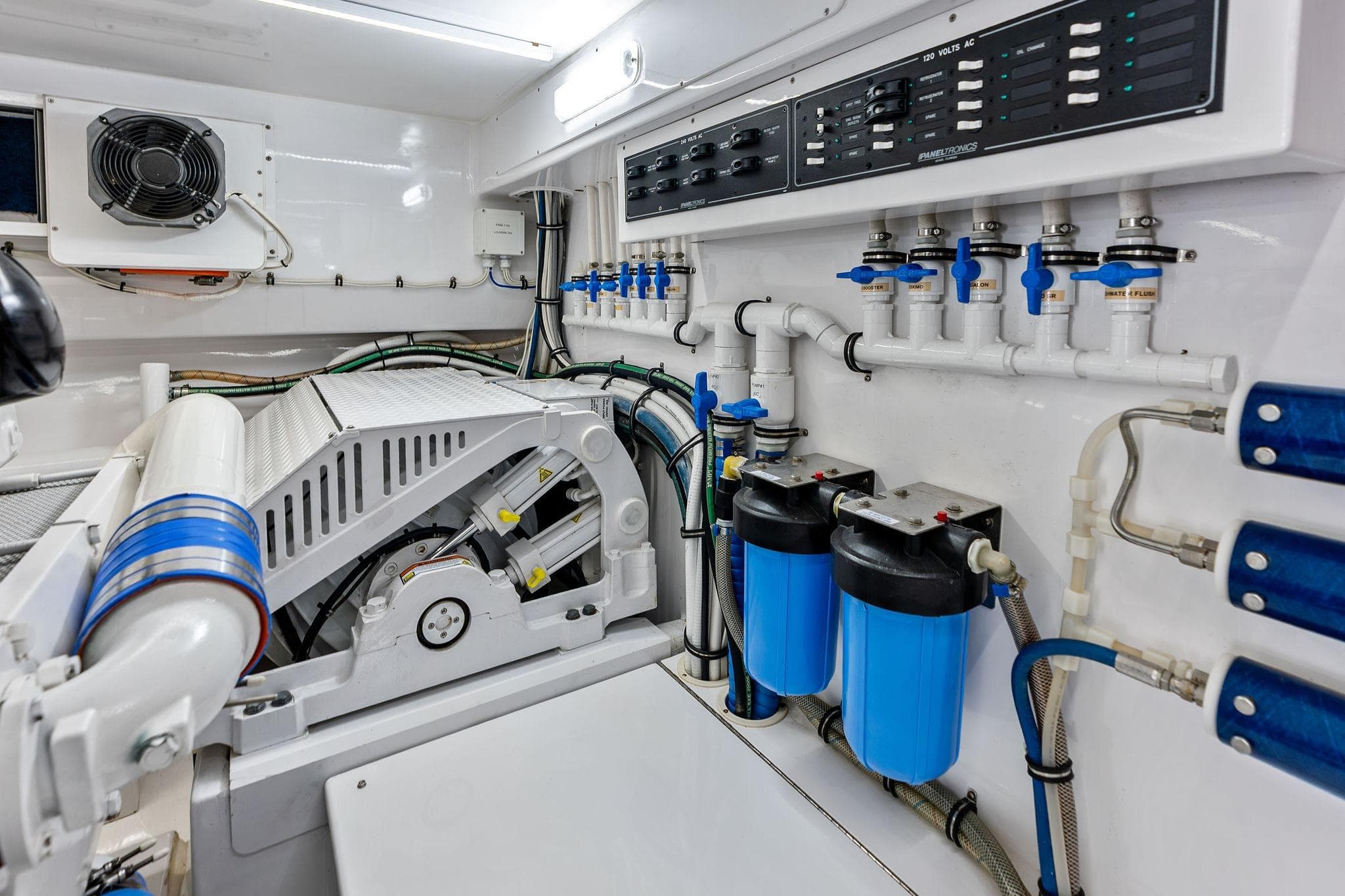 Engine room of 2017 Weaver Custom Sportfish with filtration system and control panel.