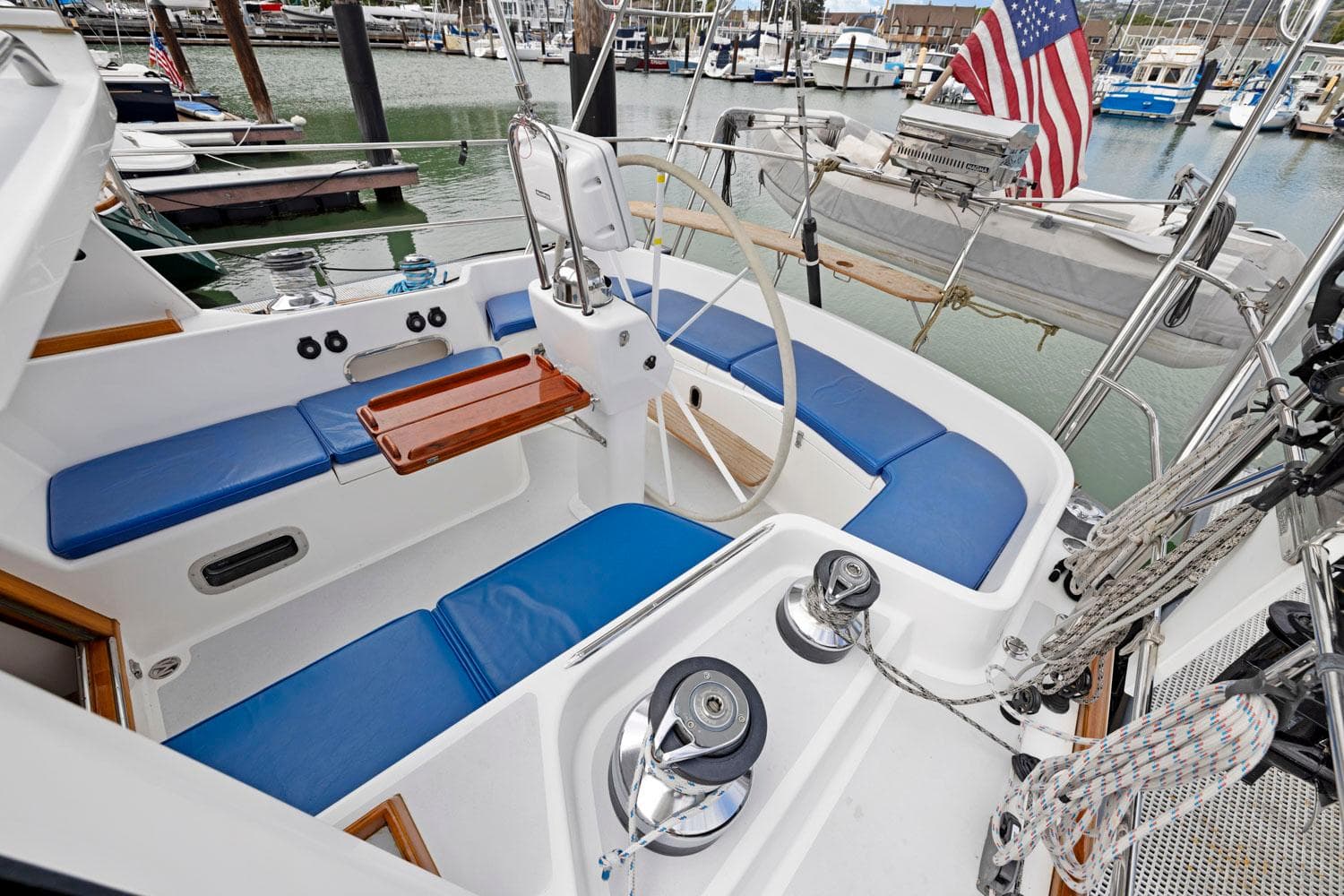 Cockpit of 2005 Morris 486 sailboat with blue seating and American flag.