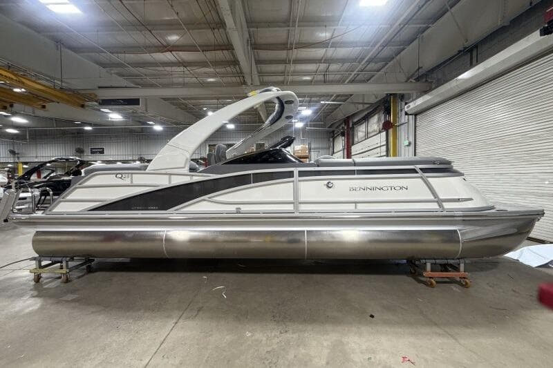 2024 Bennington 25QFBWA pontoon boat in a warehouse setting.