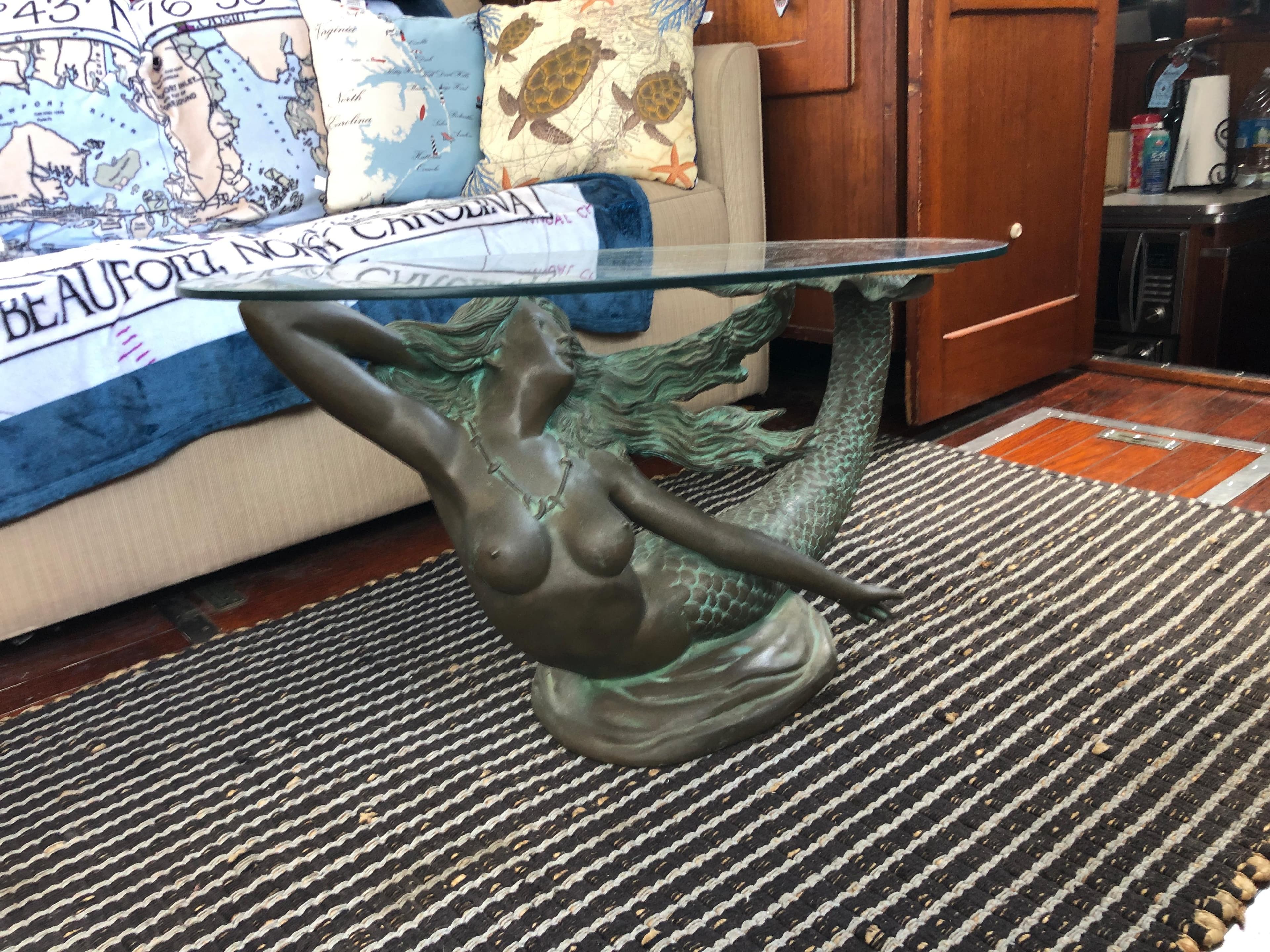 Mermaid-themed glass coffee table on striped rug in 1963 Egg Harbor Convertible Cruiser.