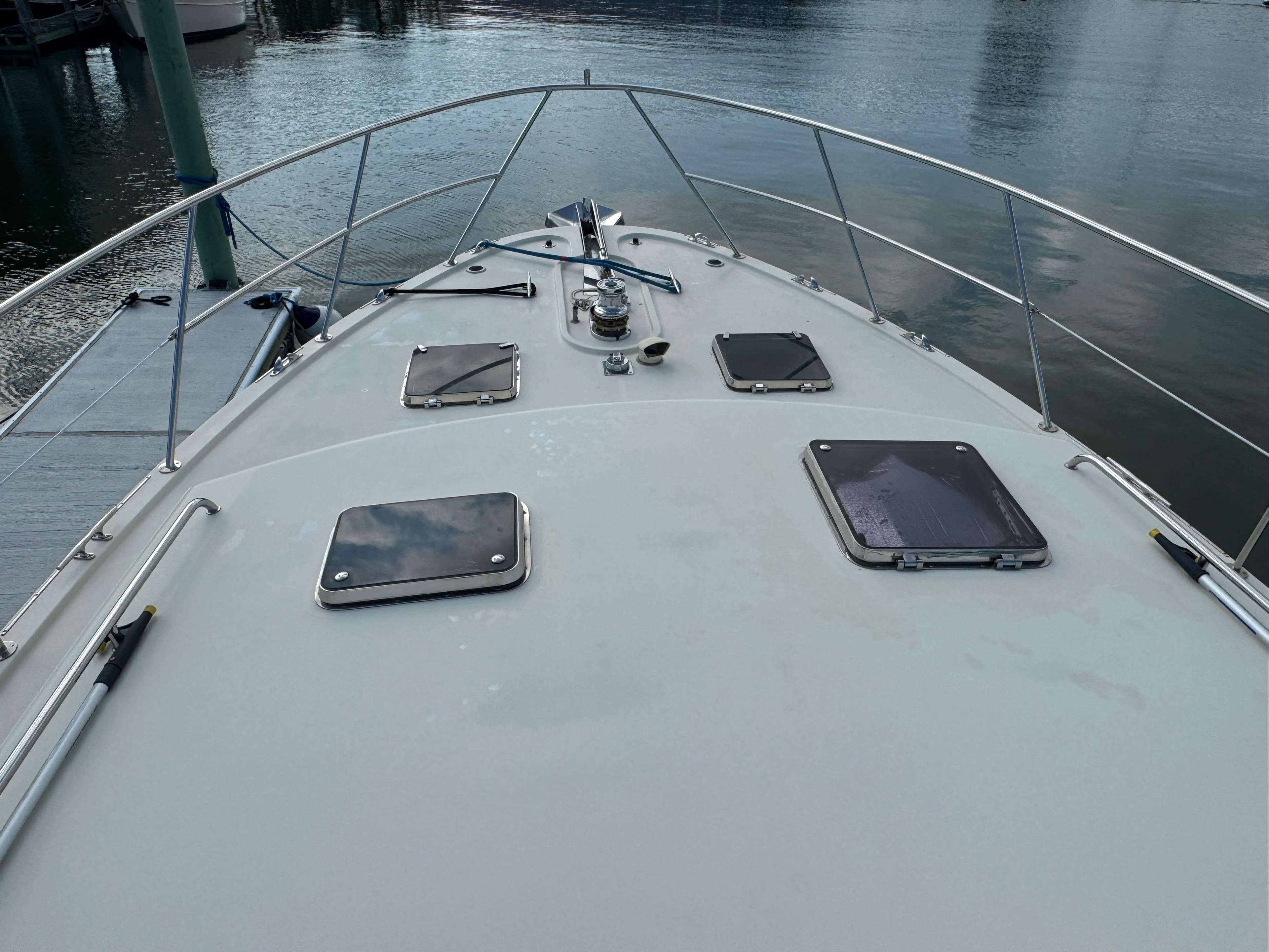 2003 Dettling 51 Express Cruiser bow view with hatches and railing.