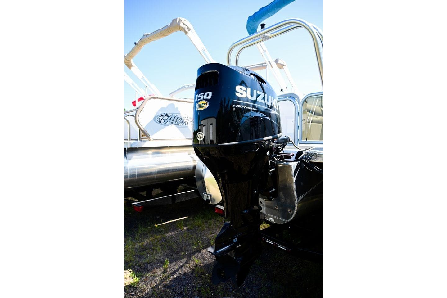 2023 Aloha Pontoon Mahalo 23 with Suzuki 150 outboard motor, side view.