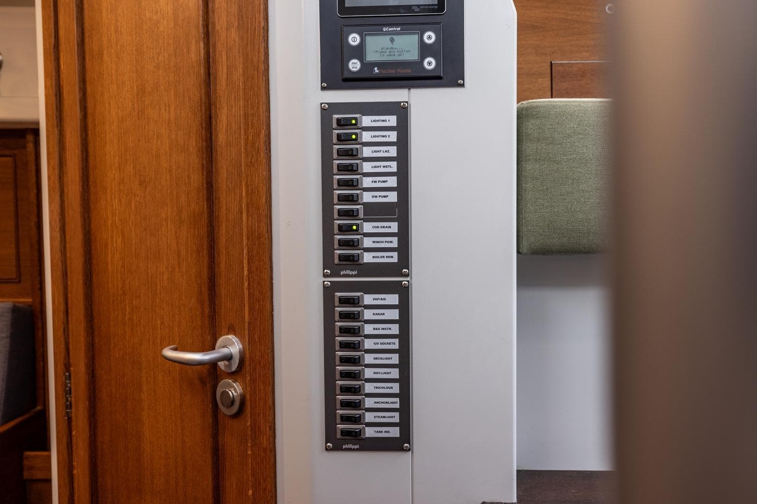 Electrical panel inside 2023 Bestevaer 36 yacht, featuring labeled switches and control display.