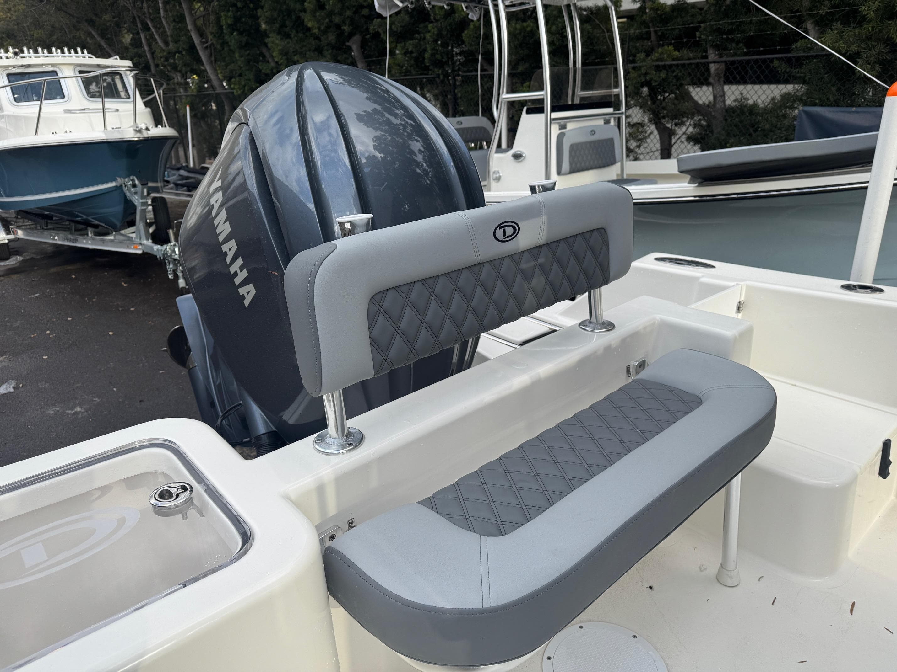 2025 Defiance Catalina 240 boat with Yamaha engine and cushioned seating.