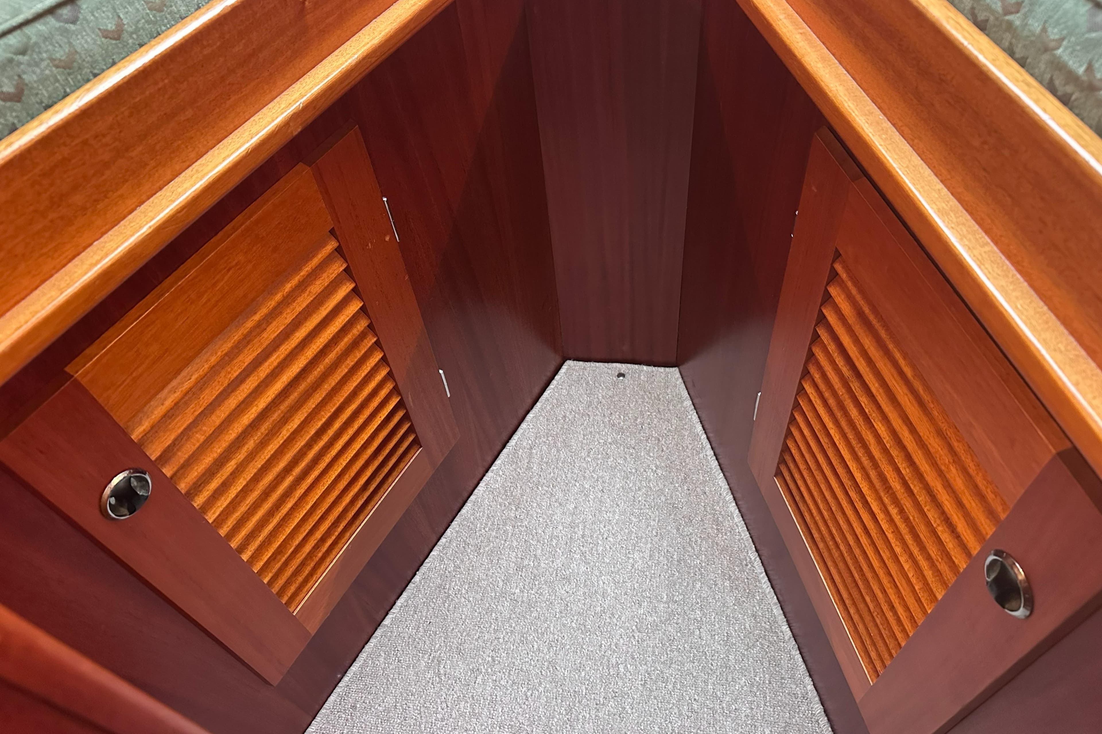 Interior view of a 2000 Hallberg-Rassy 46 yacht, featuring wooden cabinetry and carpeted flooring.