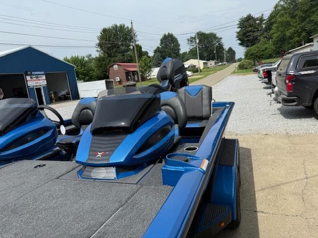 2026 Vexus 2085s boat in blue, parked outdoors on a sunny day.