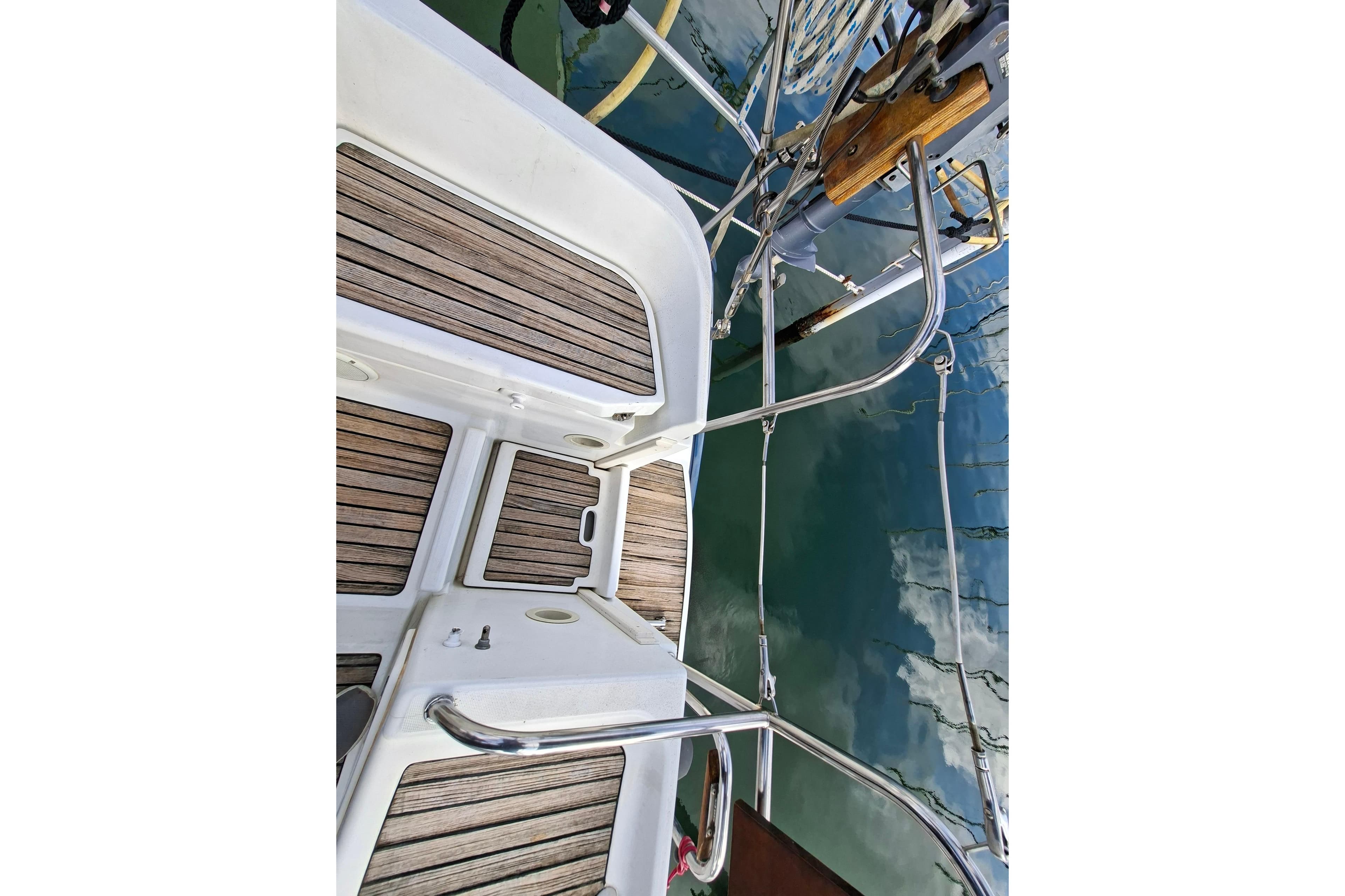 Jeanneau Sun Odyssey 43 DS 2002 yacht deck with teak flooring and stainless steel railings.