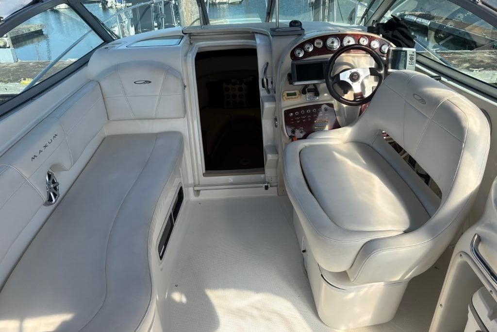 2008 Maxum 2700 SE boat interior with white seating and control panel.