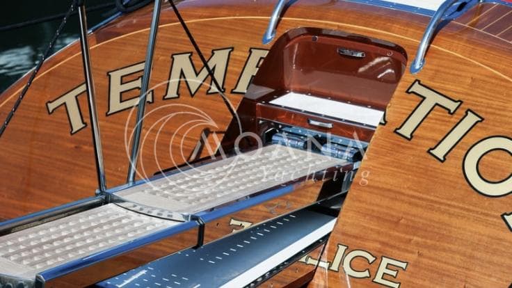 2011 J Craft Torpedo R 42 yacht with open storage compartment and sleek wooden finish.