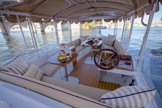 2022 Duffy Back Bay 16 boat interior with elegant seating and dining setup on the water.