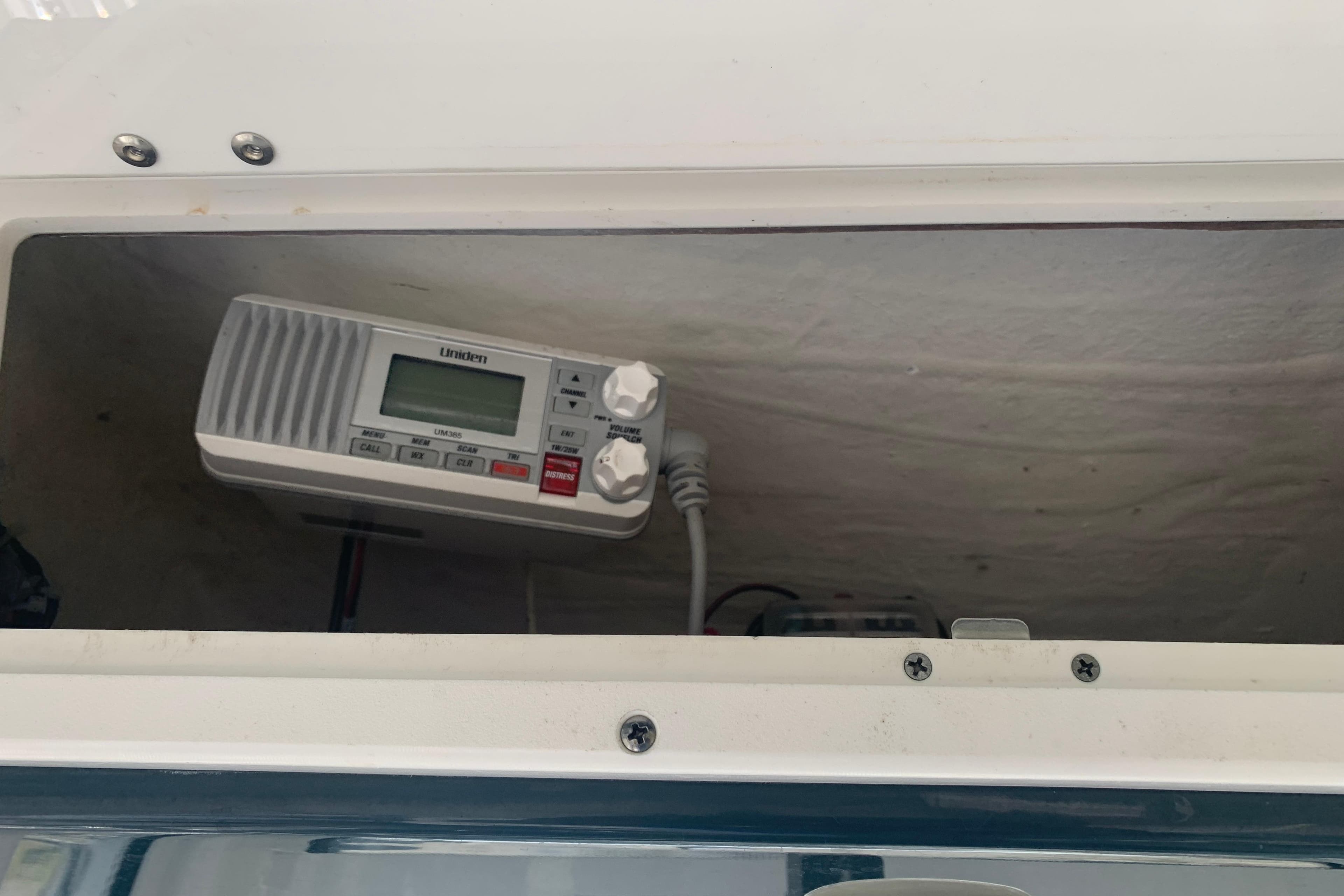 Radio equipment inside a 2021 Tidewater 256 CC Adventure boat compartment.