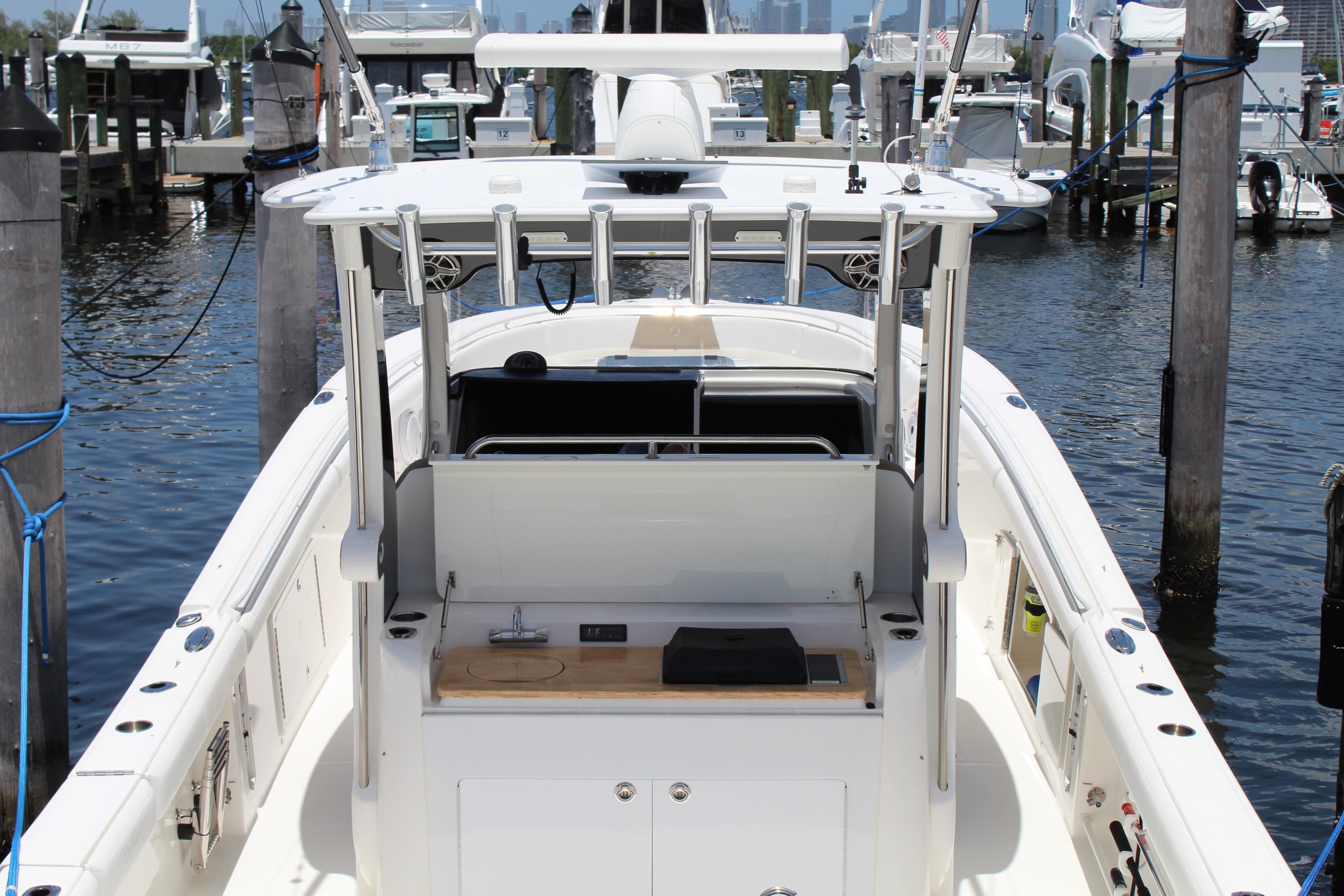 2016 Edgewater 370CC boat docked at marina, featuring spacious deck and modern amenities.