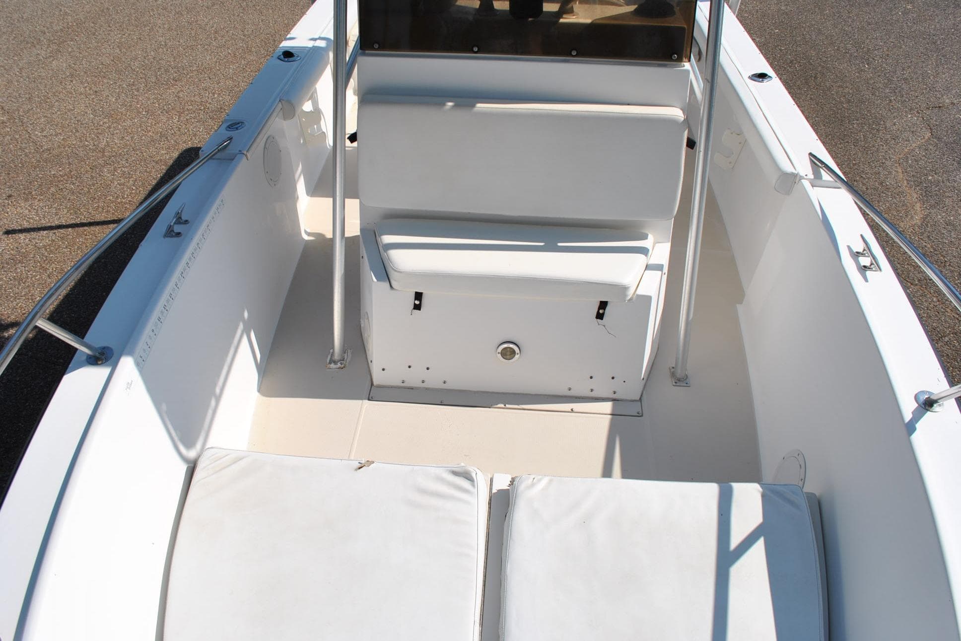 1993 Robalo 2120 Center Console boat interior with white seating and stainless steel railings.