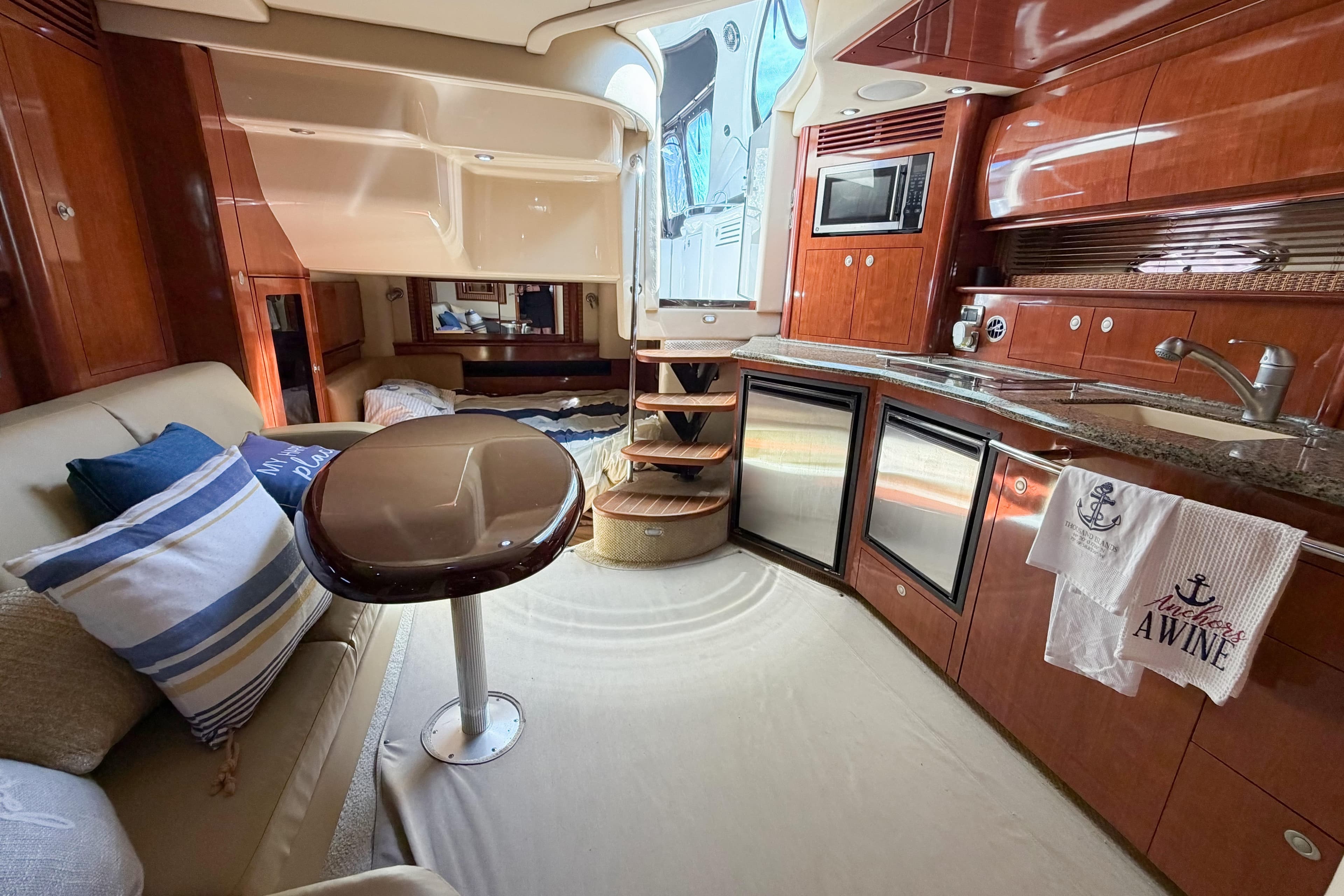 Luxurious interior of a 2005 Sea Ray 40 Sundancer yacht with elegant wood finishes.