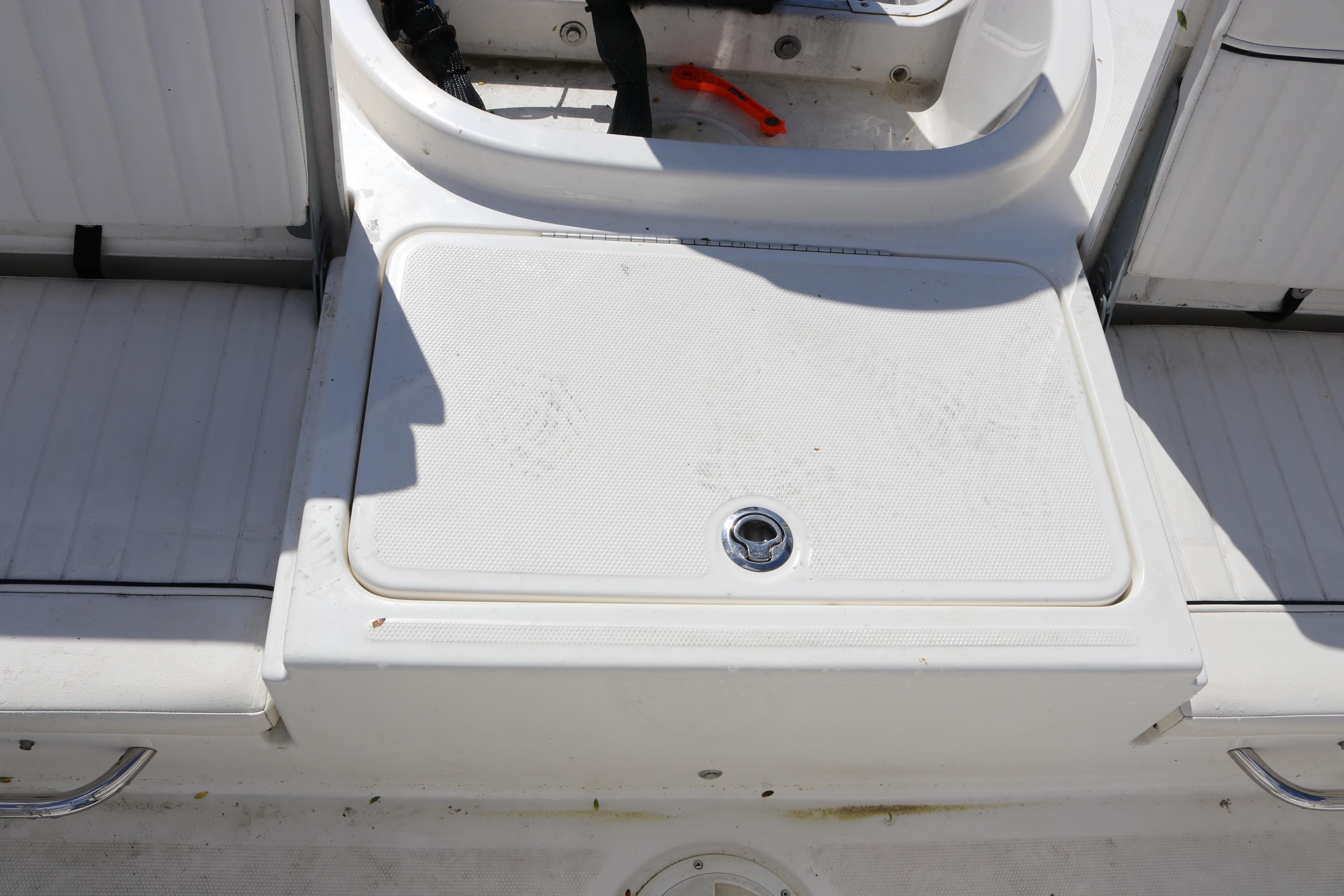 2020 Bayliner Element boat deck with storage compartment and seating area.