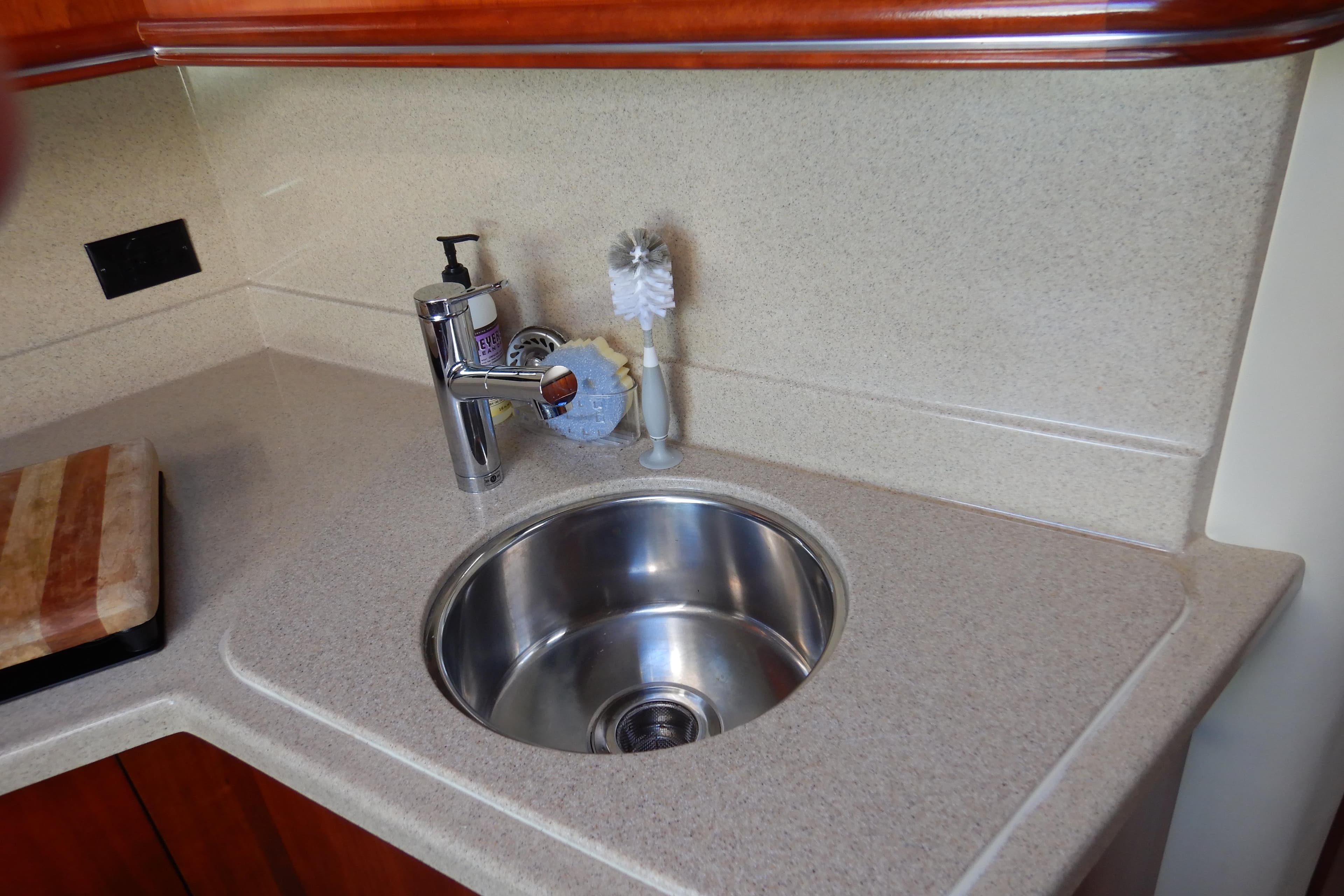 2007 Cruisers 340 Express yacht kitchen sink with countertop and faucet.