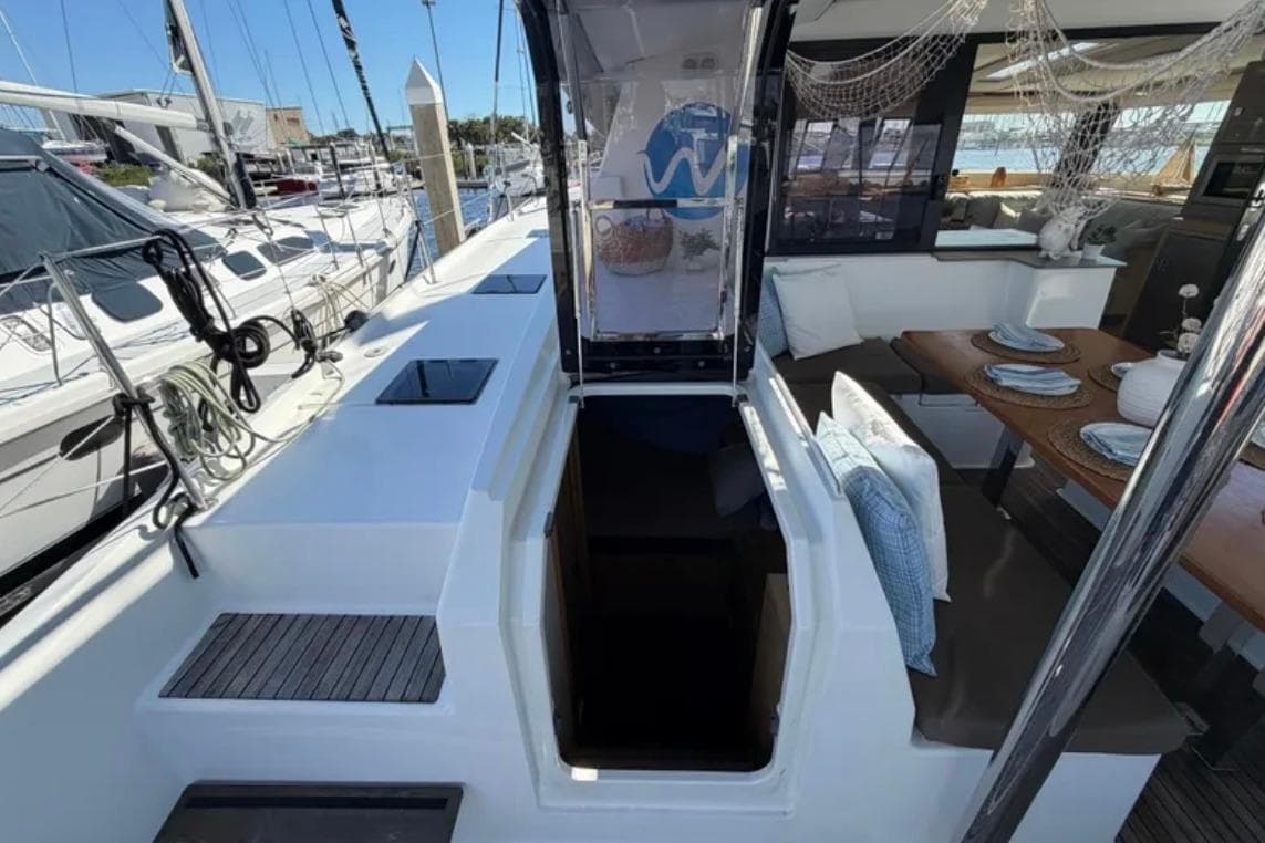 2018 Fountaine Pajot Saona 47 yacht interior with dining area and open deck view.