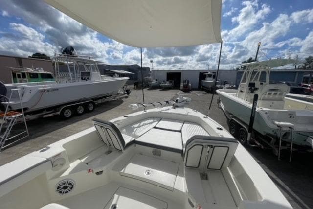 2026 Pathfinder 2600 TRS boat in a marina, surrounded by other boats under a cloudy sky.