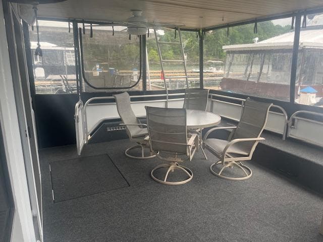 2009 Horizon 18 x 85 Houseboat interior with table and chairs on deck.