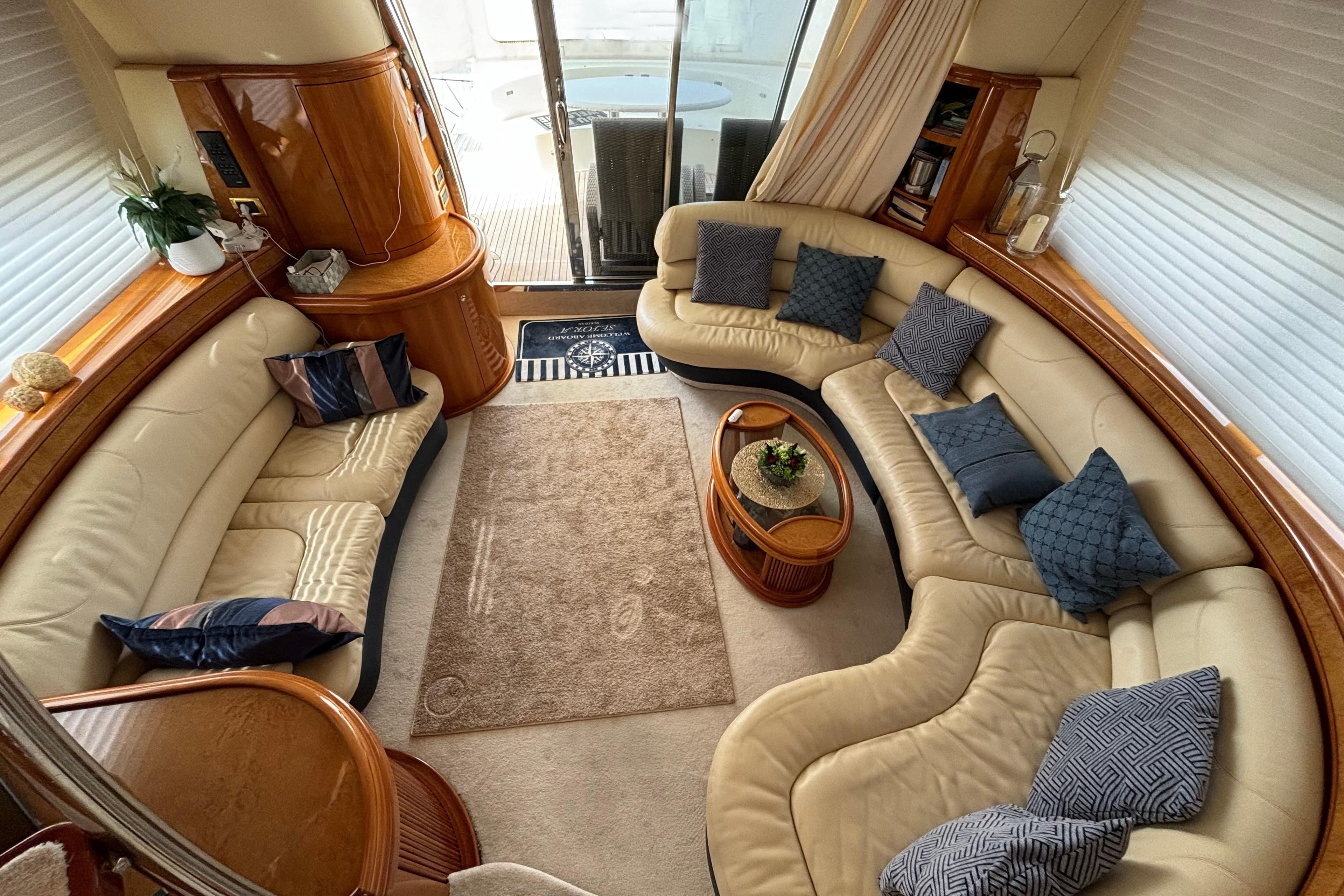 Luxurious interior of a 2002 Azimut 68 Plus yacht with elegant seating and decor.