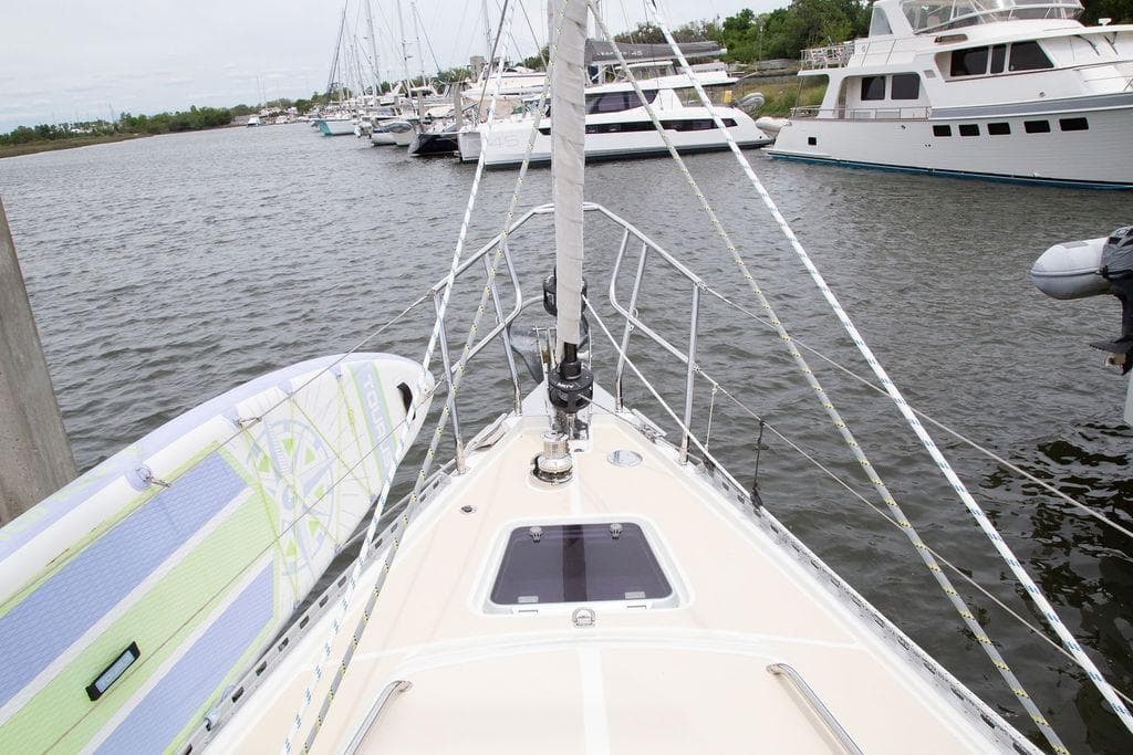 Bow view of 2015 Outbound 46 sailboat docked with paddleboard.