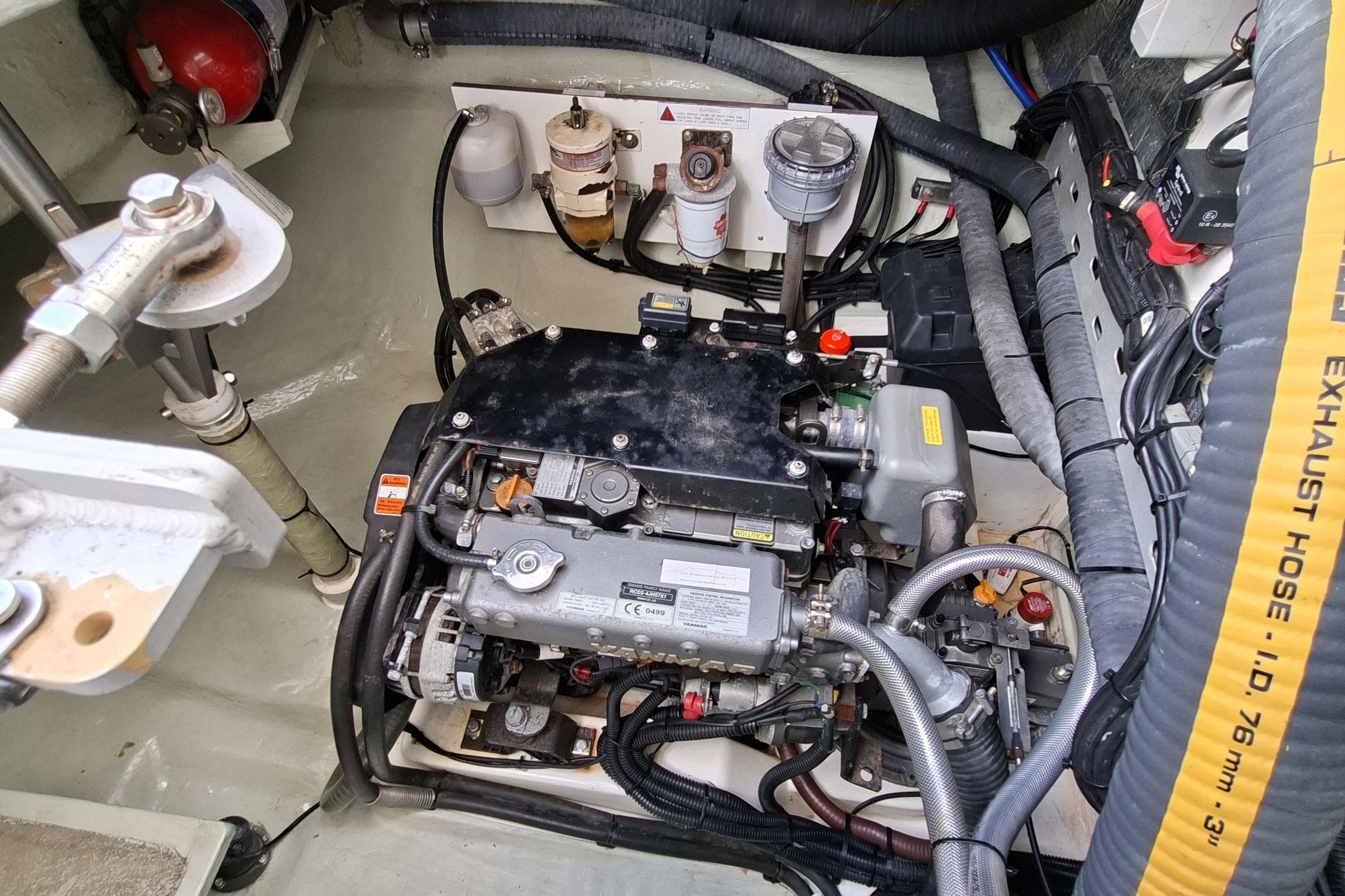 Engine compartment of a 2018 Leopard 45 catamaran, showcasing mechanical components and exhaust hose.