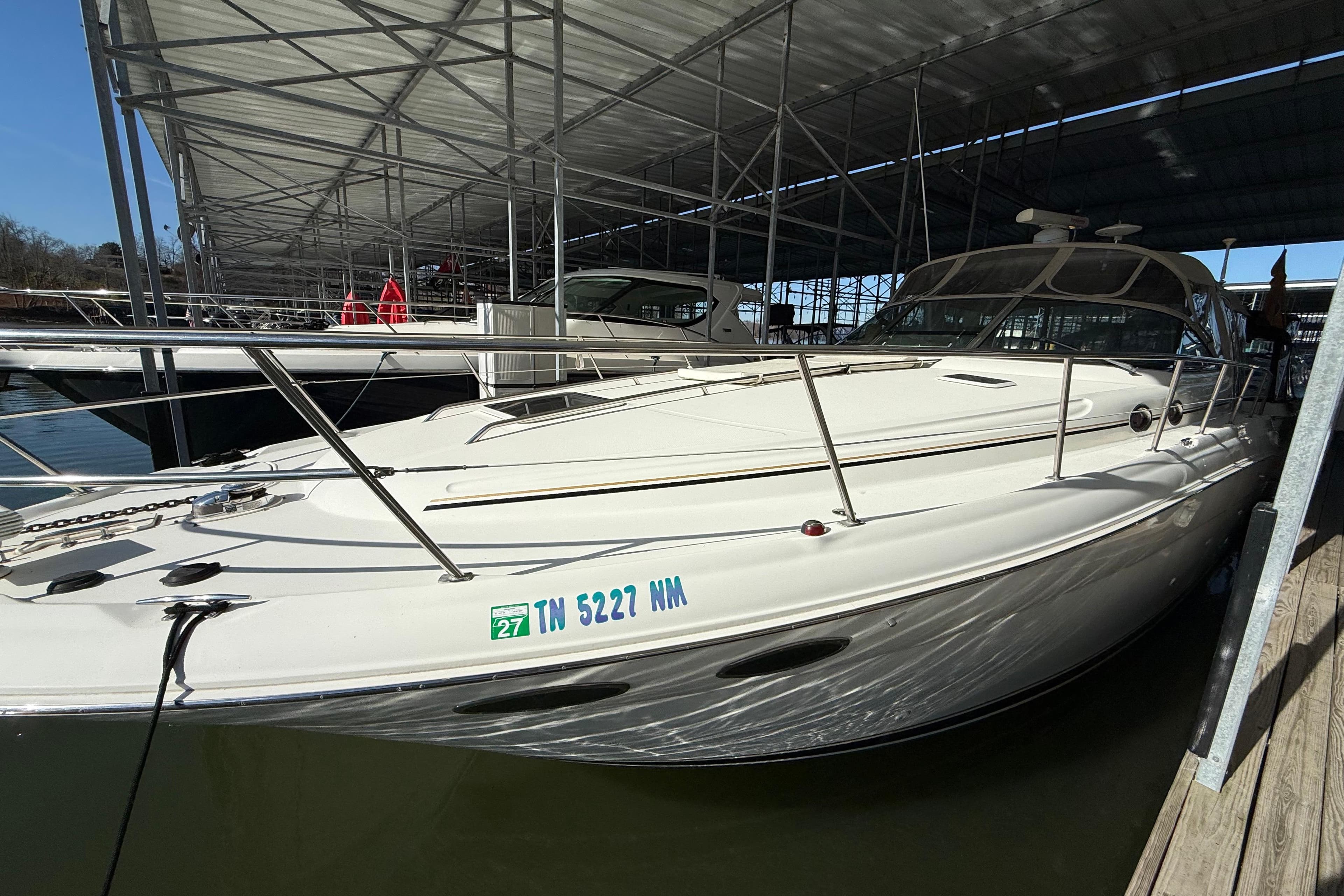 2001 Sea Ray 380 Sundancer docked under a covered marina.