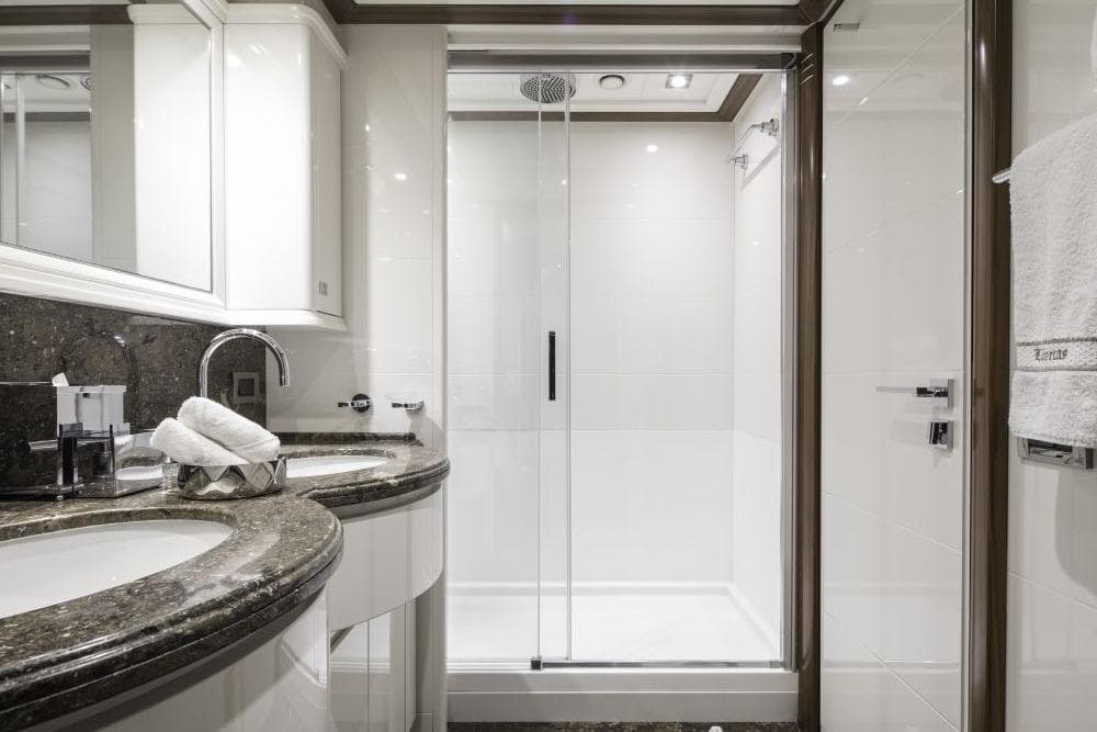 Luxurious yacht bathroom with modern fixtures, granite countertop, and glass shower, CRN 129, 2009.
