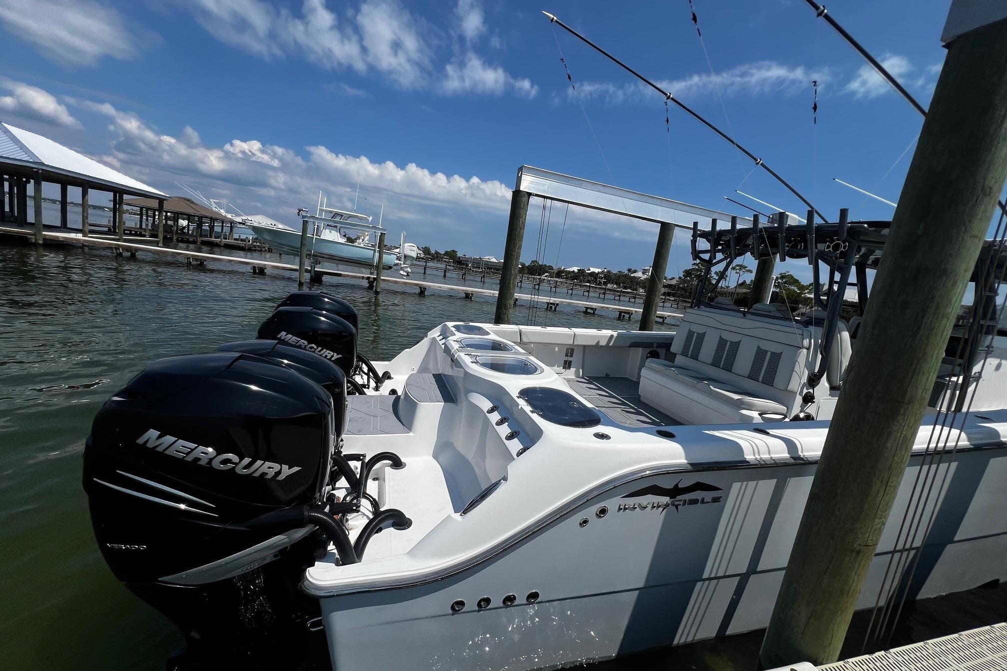2022 Invincible 46 Catamaran with Mercury engines docked under a clear blue sky.