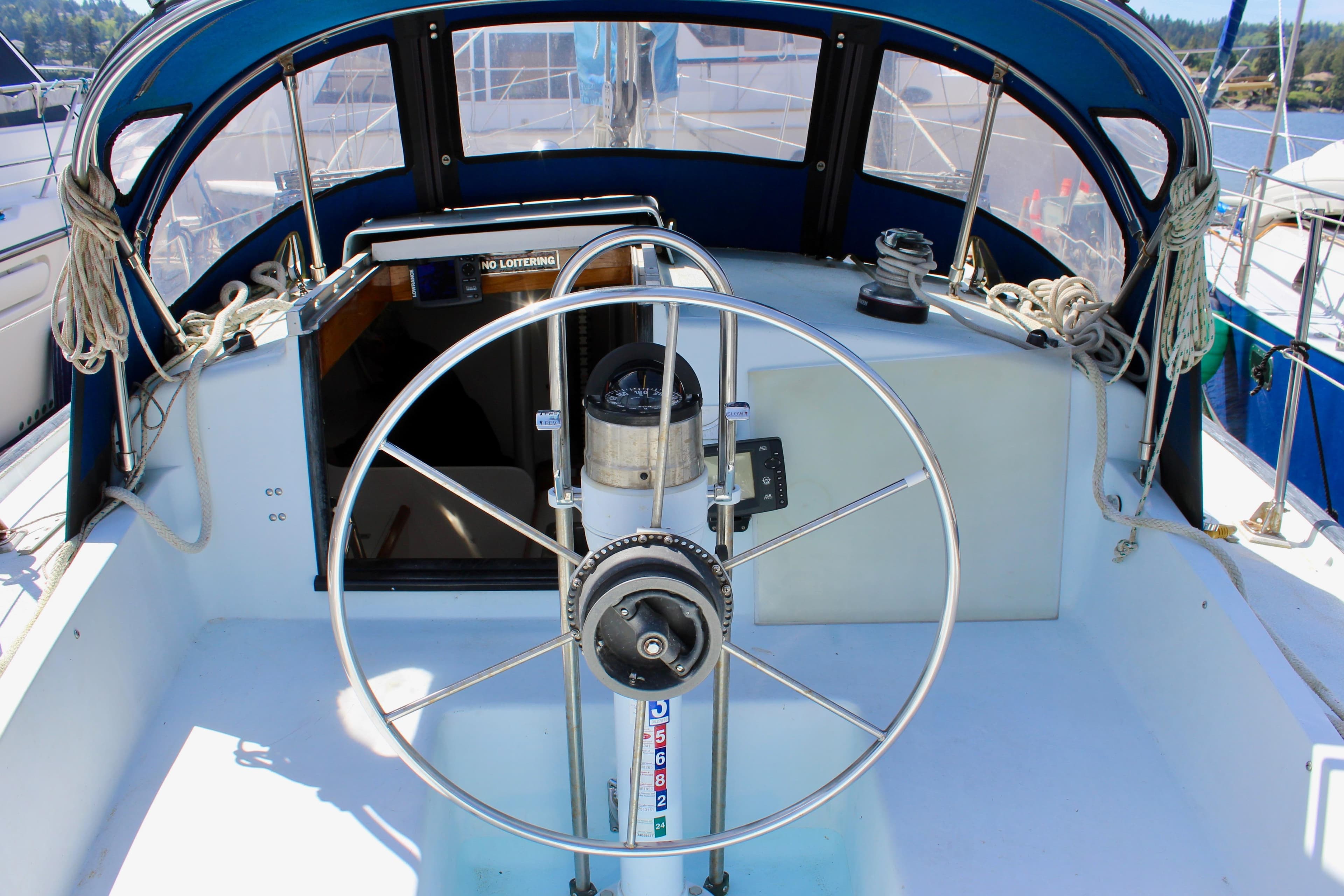 Cockpit of 1993 Freya 39 sailboat with steering wheel and nautical equipment.