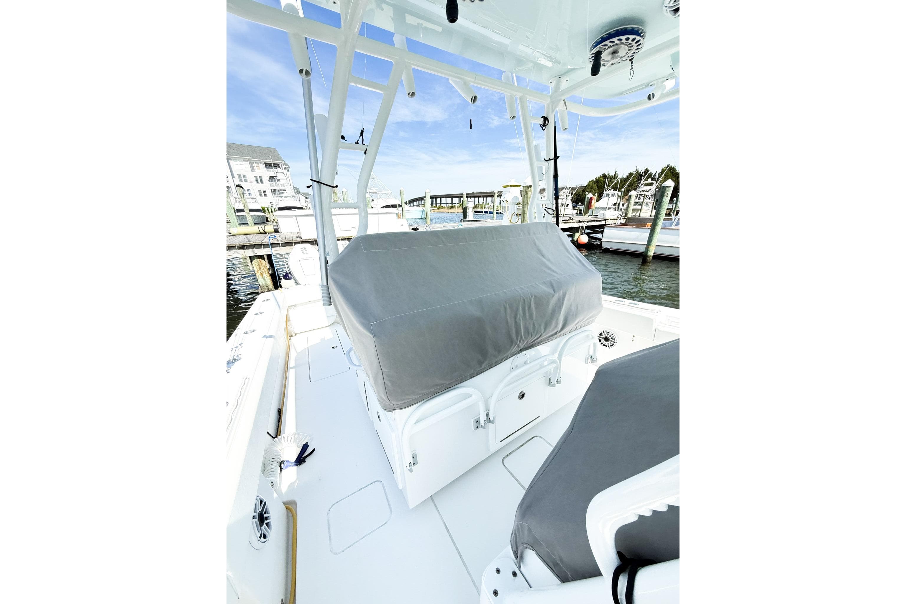 2022 Onslow Bay 41 Tournament boat interior with covered seating at a marina.
