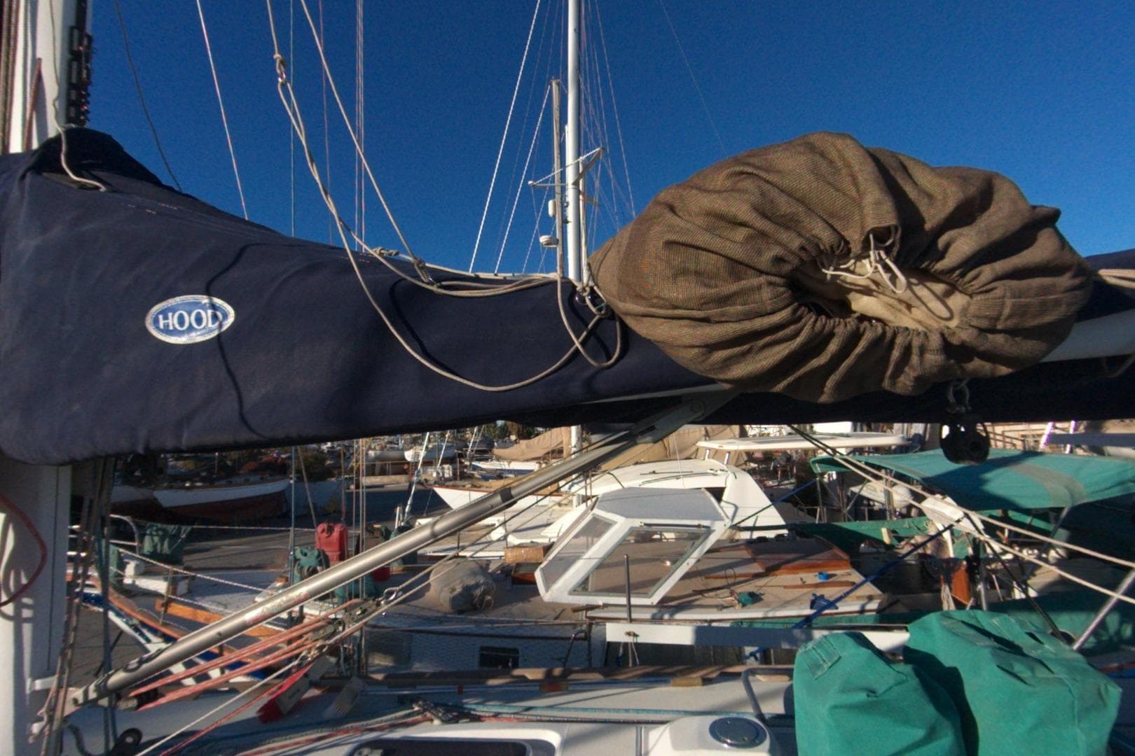Sailboat Sabre 402 from 1999 with covered boom and rigging in marina.