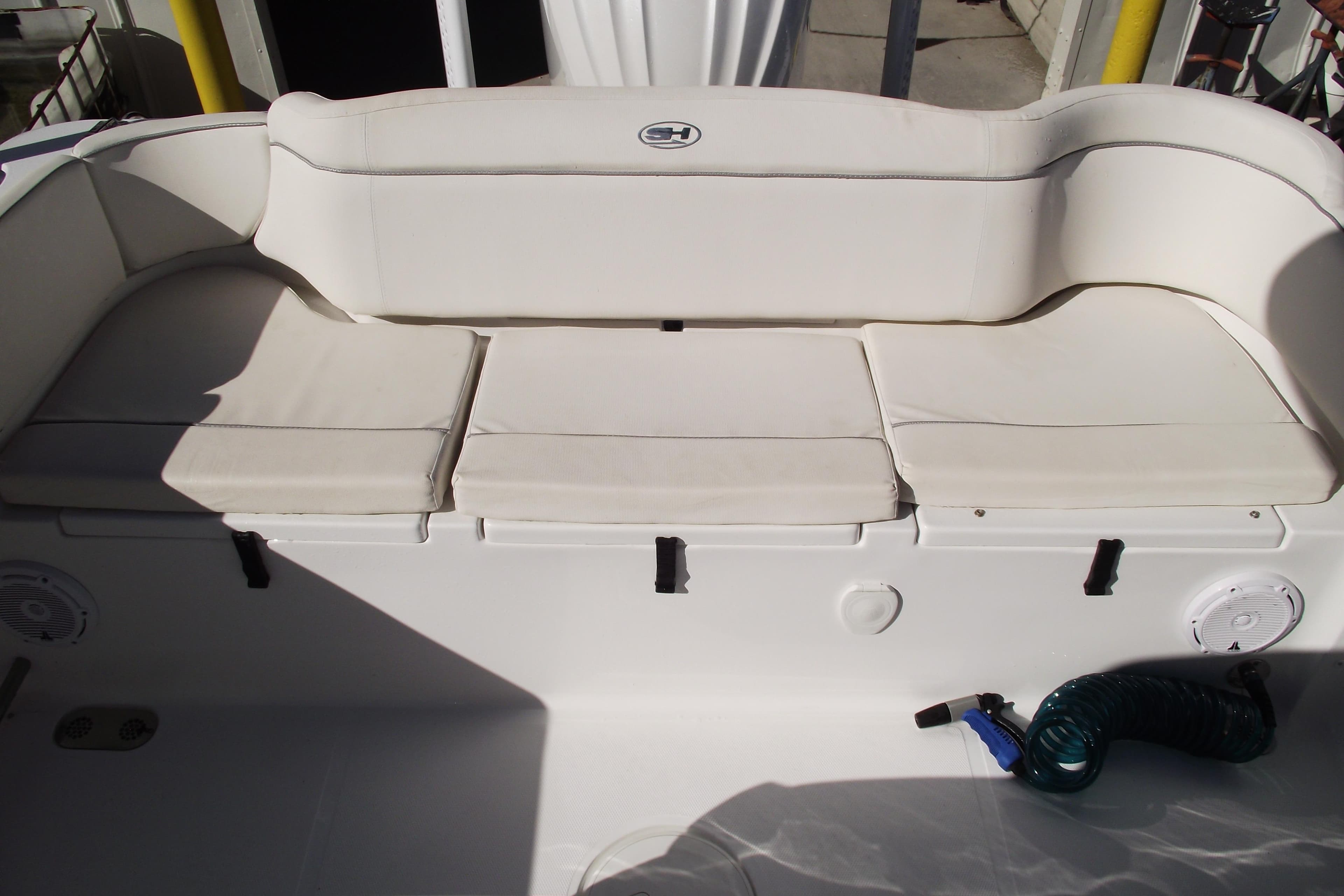 2023 Sea Hunt Ultra 255 SE boat with cushioned seating and storage compartments.