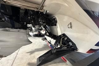 2021 Velocity 290 Sport Cruiser boat engine and propeller detail in a garage setting.